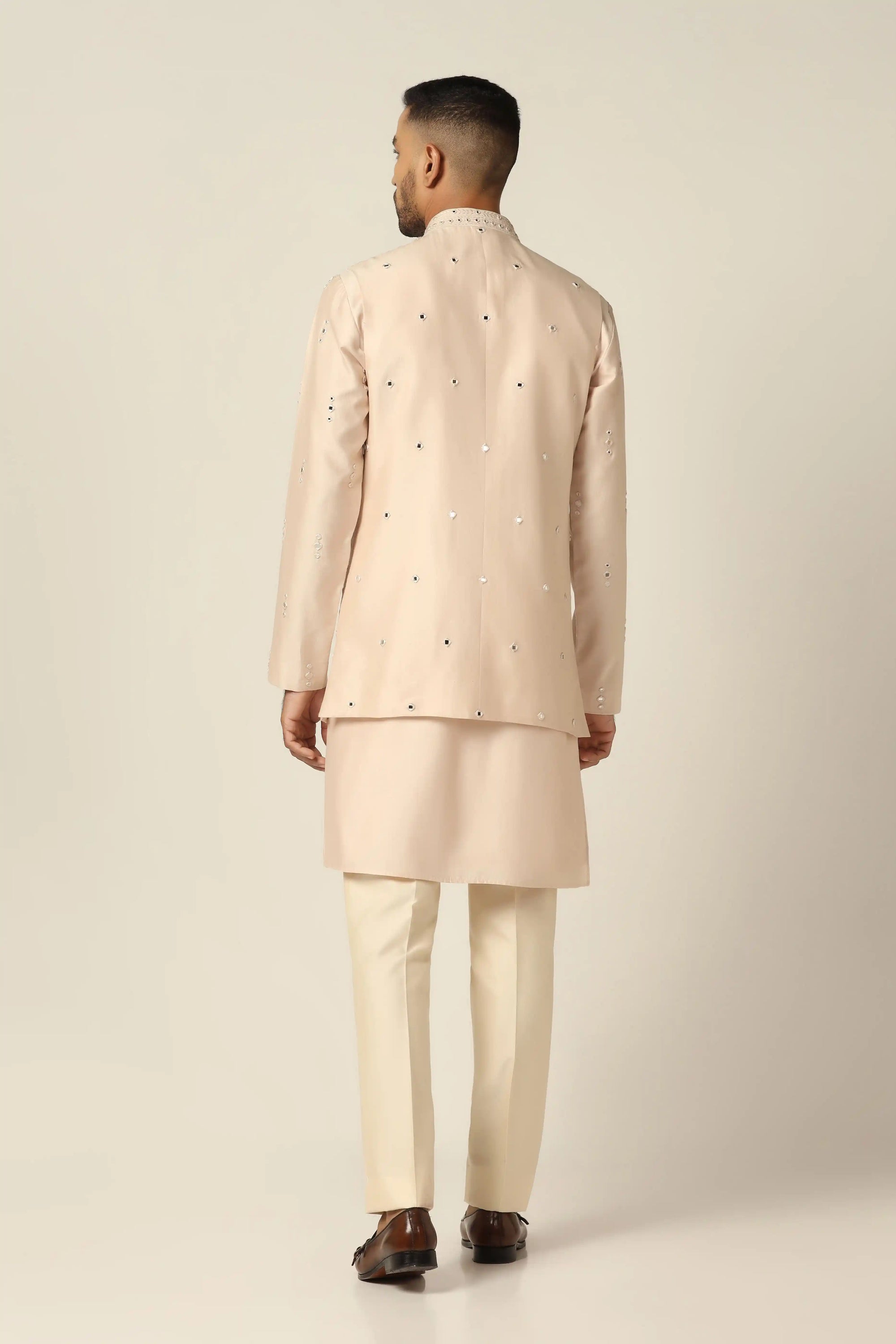Add elegance to your wardrobe with the Peach Embroidered Nehru Set. Shop now!