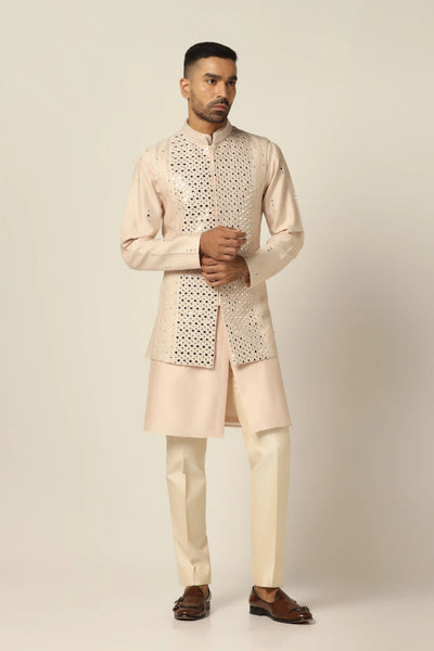Elevate your style with our Nehru set featuring intricate geometric mirror embroidery. Paired perfectly with a matching kurta and off-white trouser for a striking ensemble.