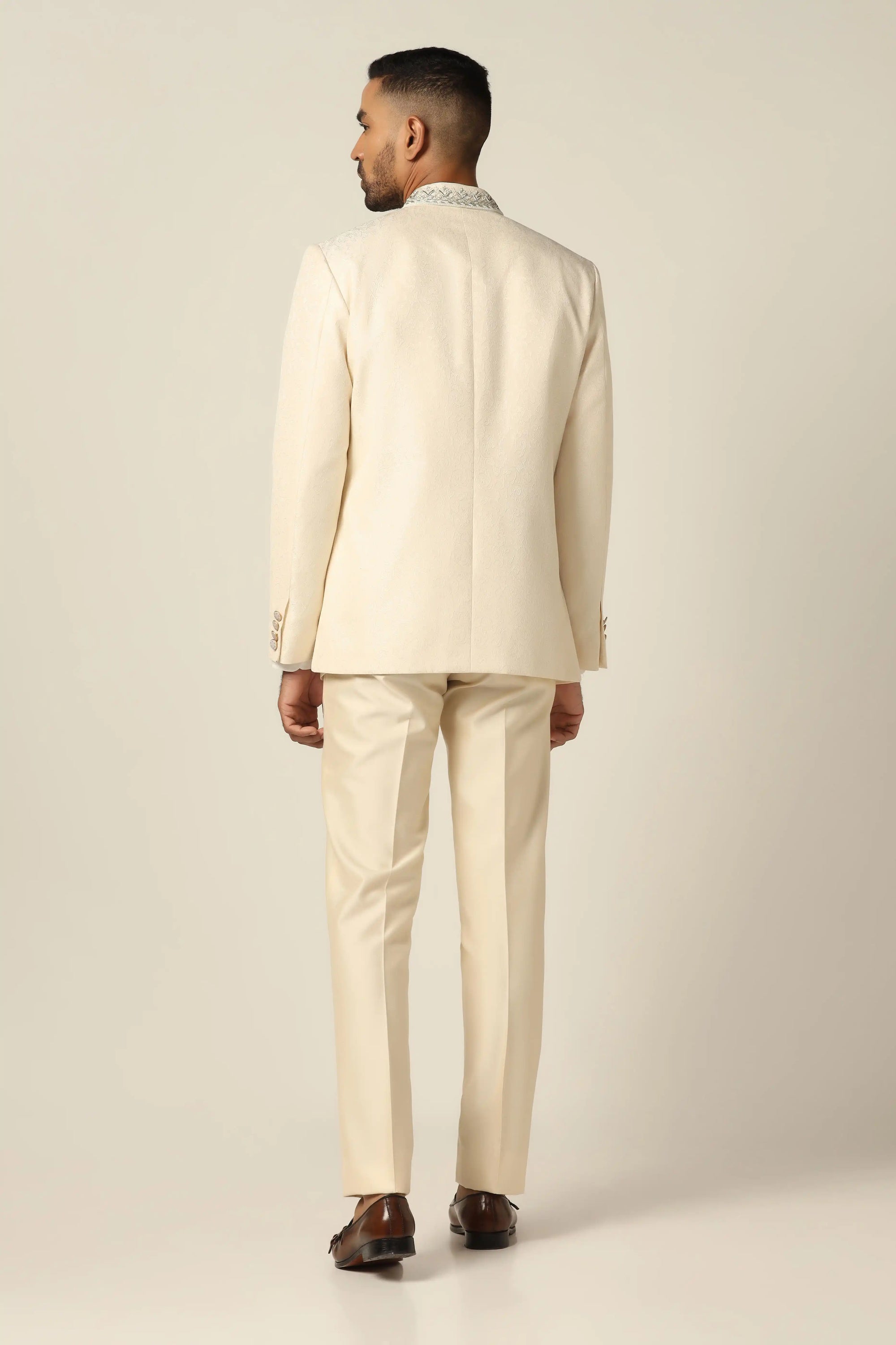 Unveil timeless elegance with a white bandhgala suit, showcasing intricate embroidery work. Buy Now!