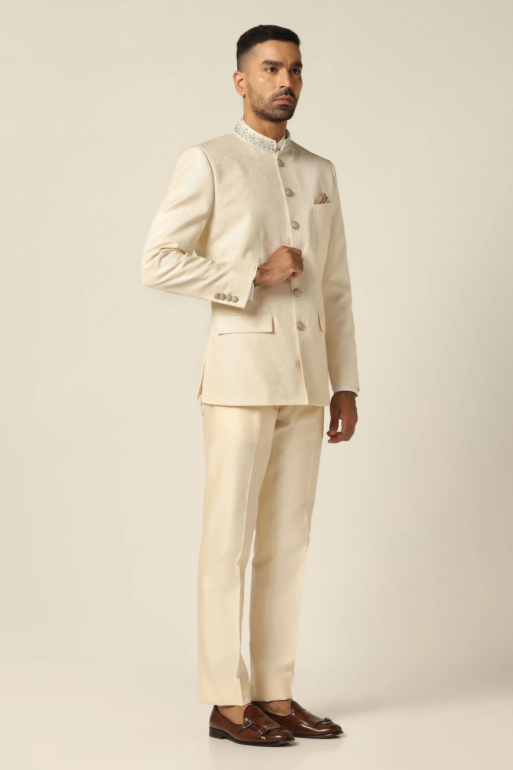 Unveil timeless elegance with a white bandhgala suit, showcasing intricate embroidery work. Buy Now!