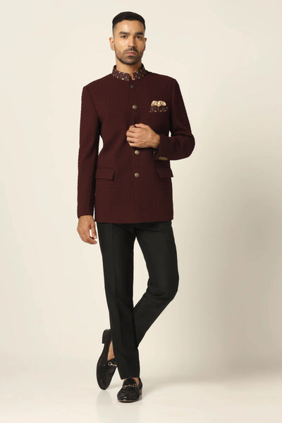 Elevate your style with our textured Bandhgala suit, adorned with golden buttons and matching embroidery on the collar and chest pocket. Paired with jet black trousers for a refined look.