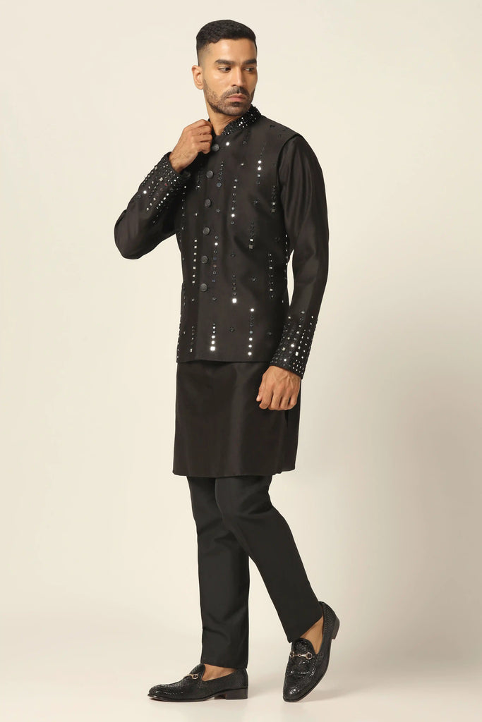 Experience luxury in our Chanderi Silk Nehru set, adorned with subtle mirror embroidery. Paired with a matching Kurta and black trousers for refined elegance.