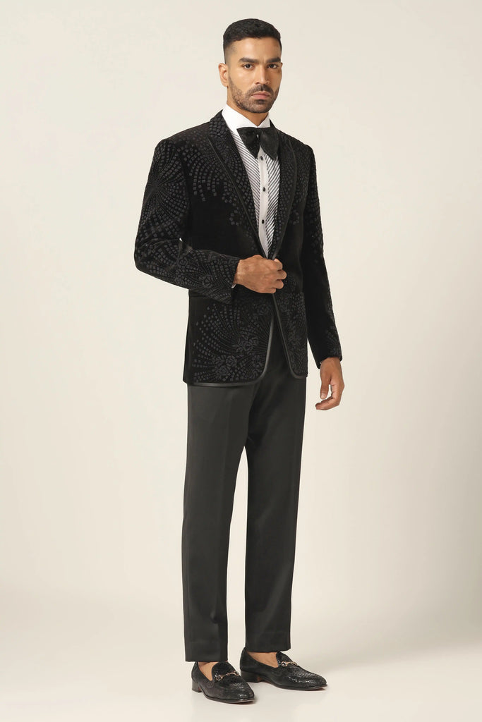 Step into luxury with our Cotton Velvet Tuxedo. Shawl collar, floral embroidery adorns the coat. Jet black Trouser completes the ensemble.
