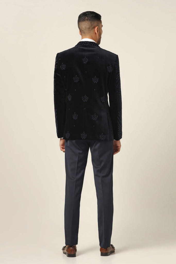 Elevate your style with our Cotton Velvet Tuxedo. Shawl collar, floral embroidery accentuates the coat. Jet black Trouser completes the ensemble.