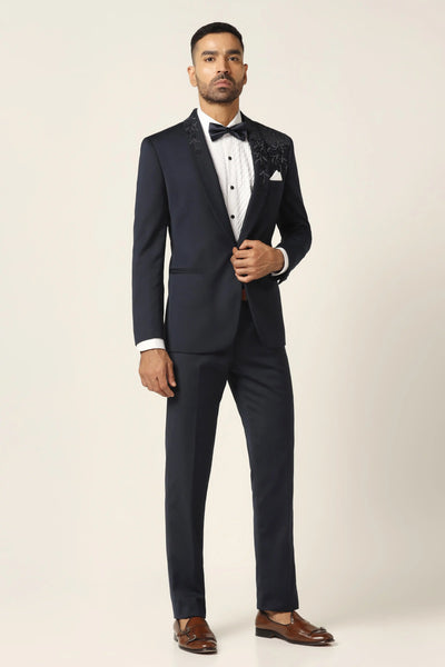 Elevate your formal look with our Navy Blue Contrast Tuxedo. Hand-embroidered lapel and shoulder detail, complete with matching Trouser.