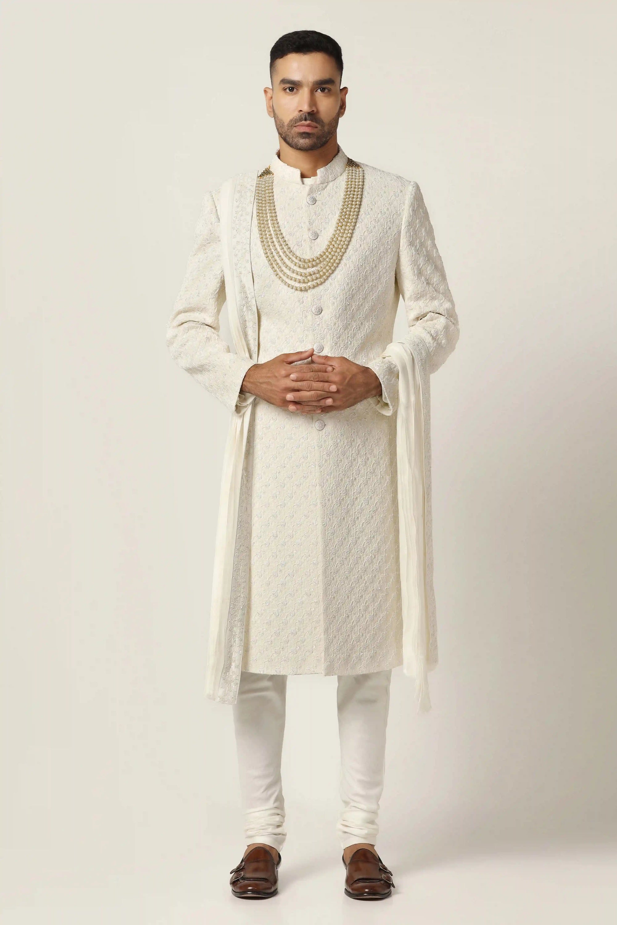 Drape in luxury with our Raw silk Sherwani set, intricately hand-embroidered throughout.  Shop Now!