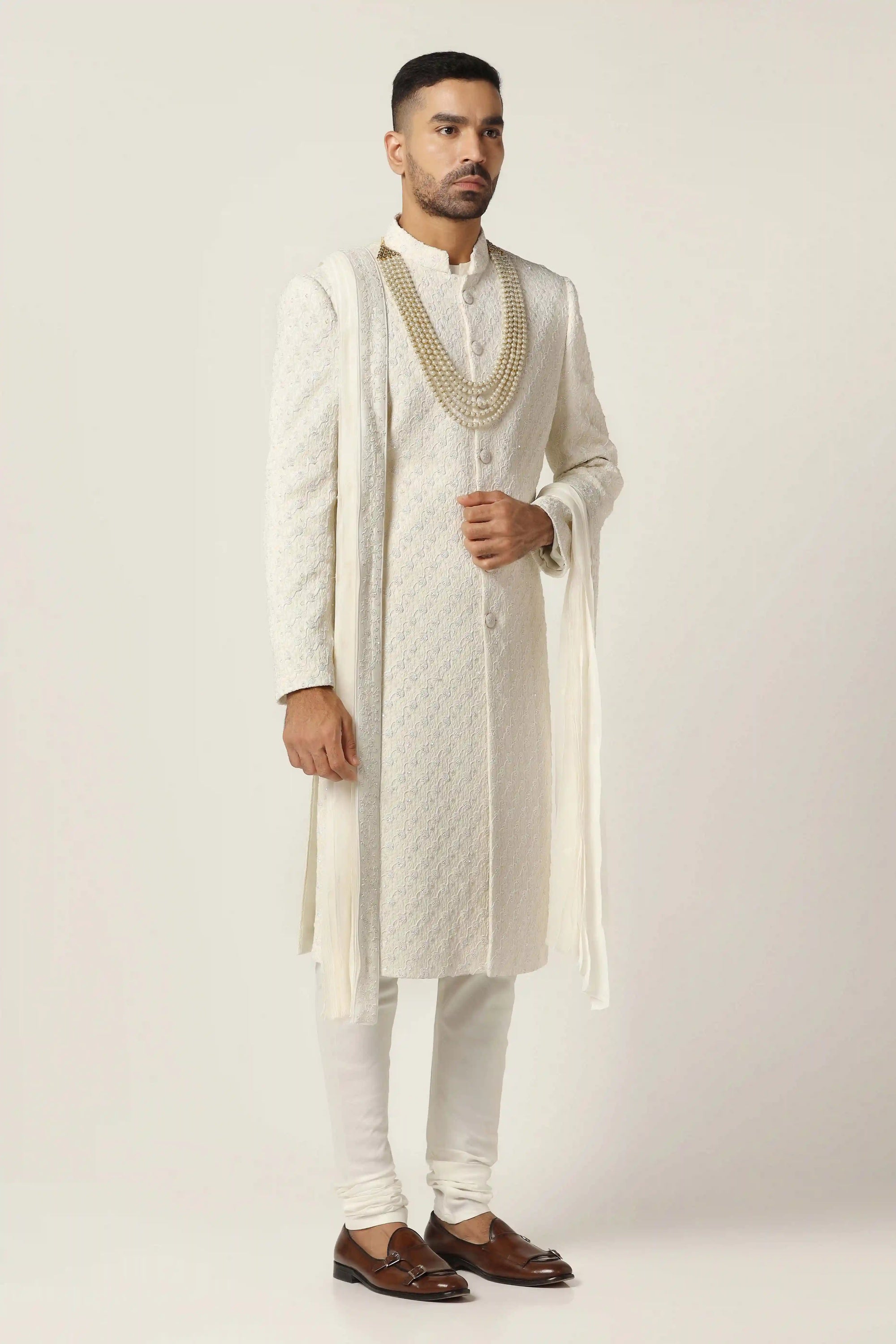 Drape in luxury with our Raw silk Sherwani set, intricately hand-embroidered throughout.  Shop Now!