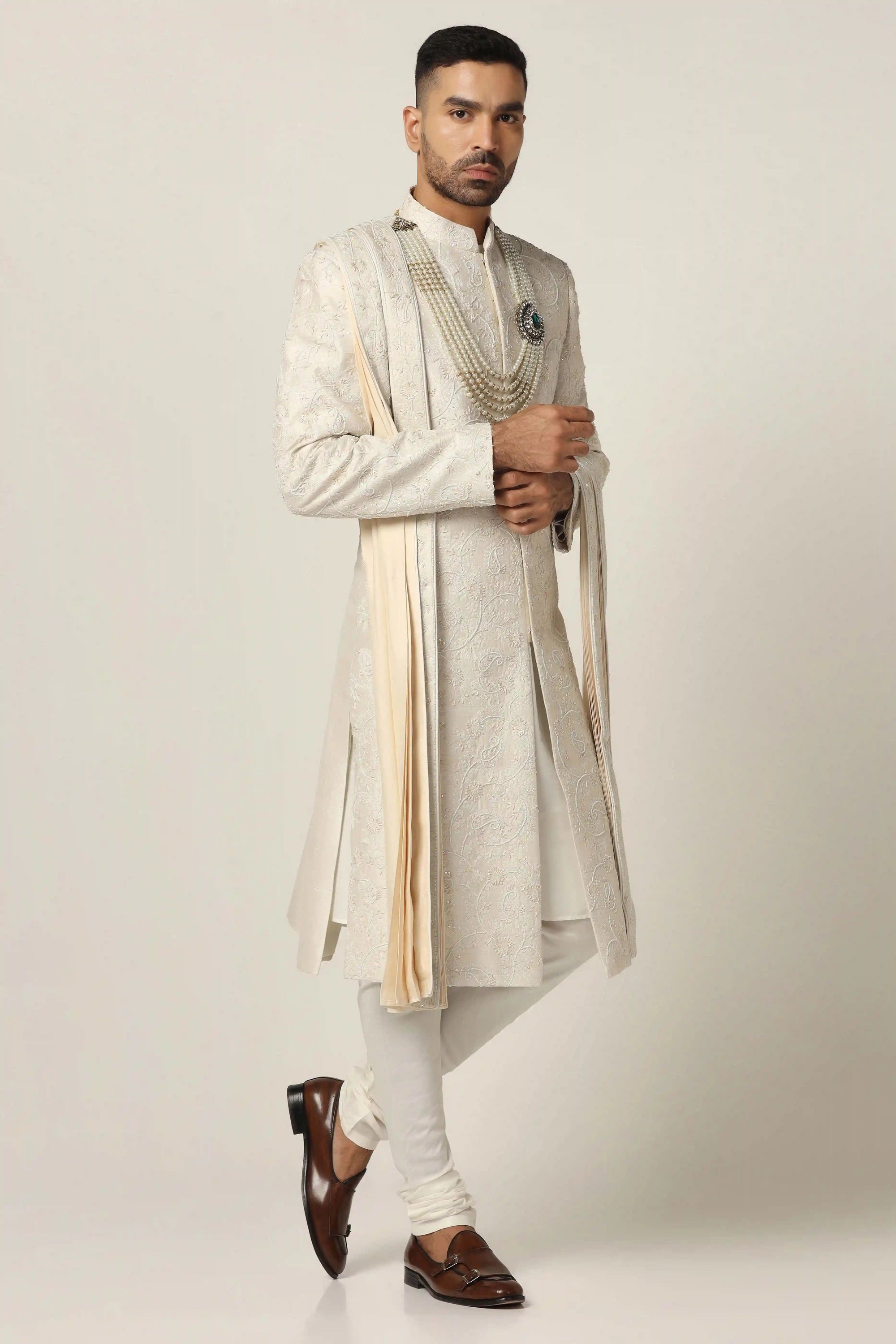 Indulge in luxury with our Raw silk Sherwani set, adorned with hand machine embroidery. Shop Now!