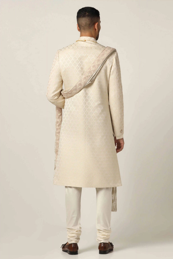 Elevate your style with our Raw silk Sherwani set, showcasing intricate geometric pattern embroidery. Complete with Kurta & Pajama for a refined look.