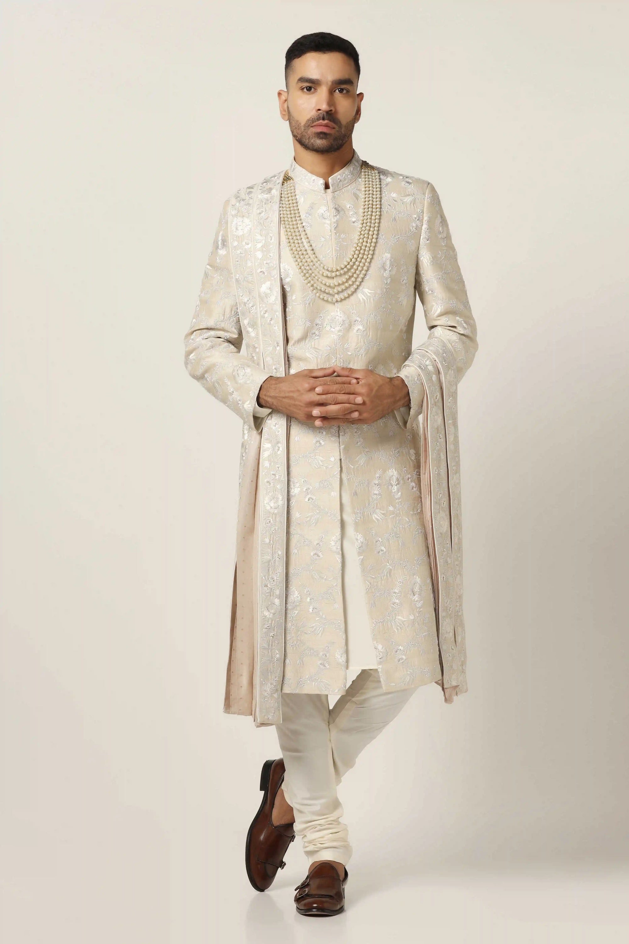 Crafted from raw silk, this Sherwani exudes elegance with intricate machine embroidery. Shop Now!
