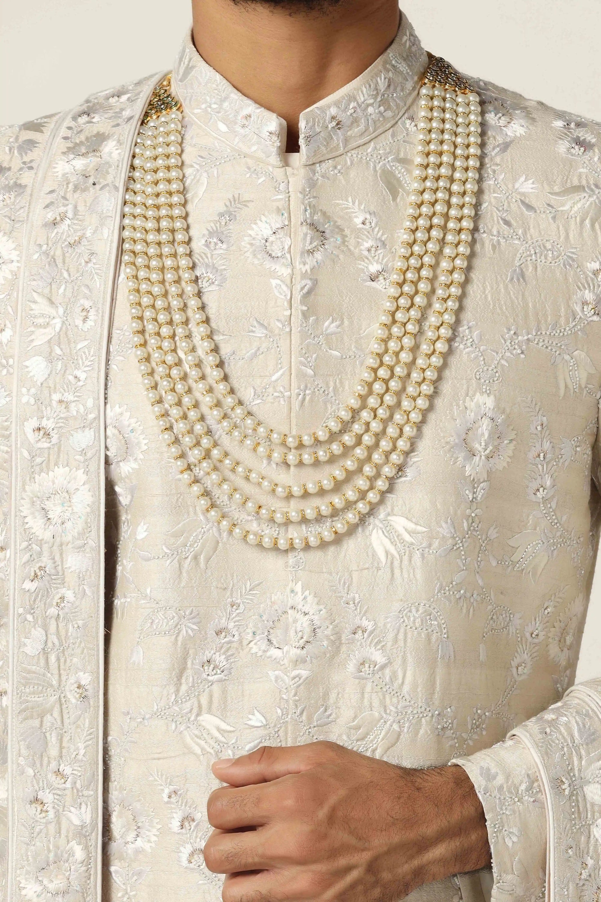 Crafted from raw silk, this Sherwani exudes elegance with intricate machine embroidery. Shop Now!