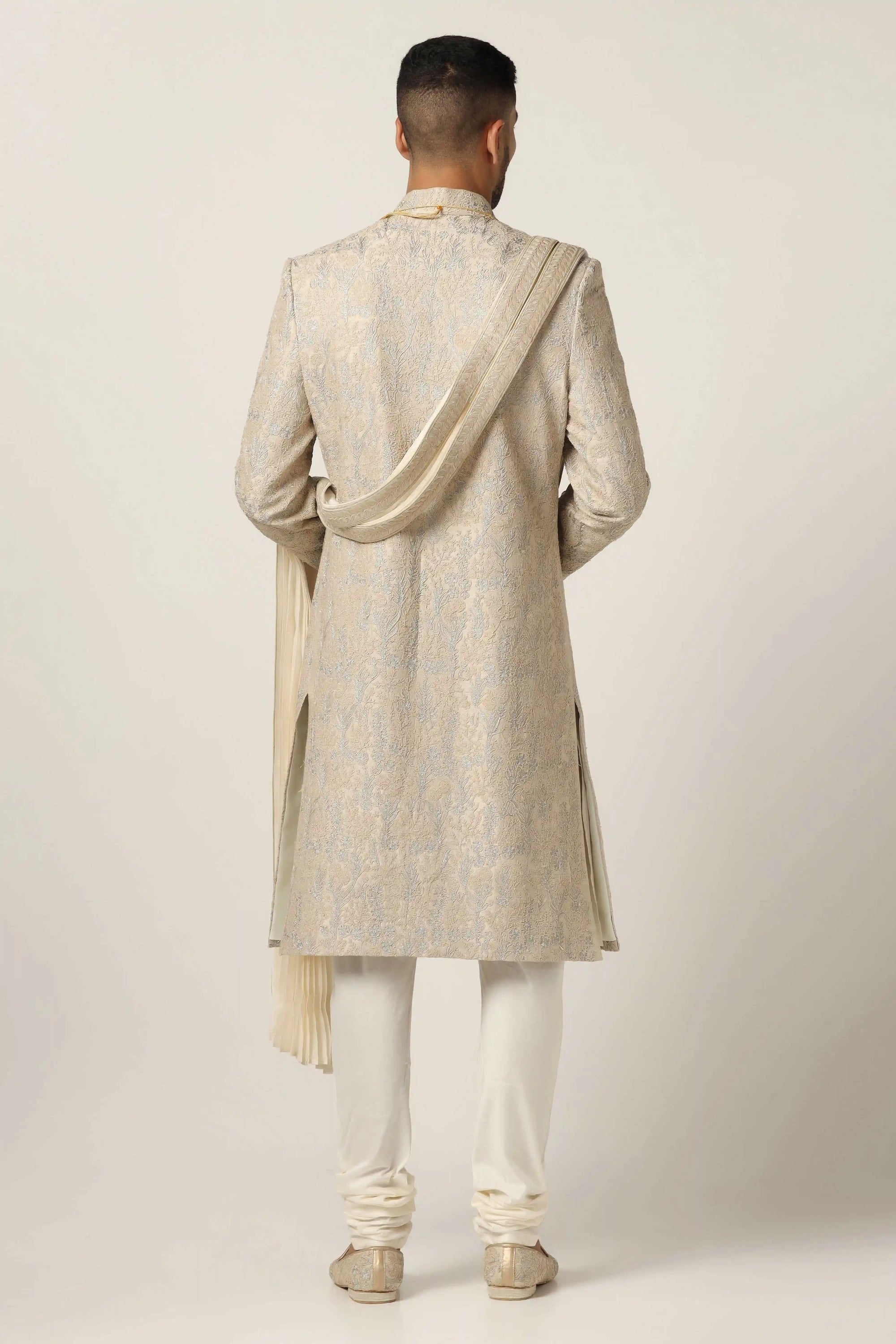 Drape in luxury with our Raw silk Sherwani set, boasting machine embroidery throughout. Shop Now!
