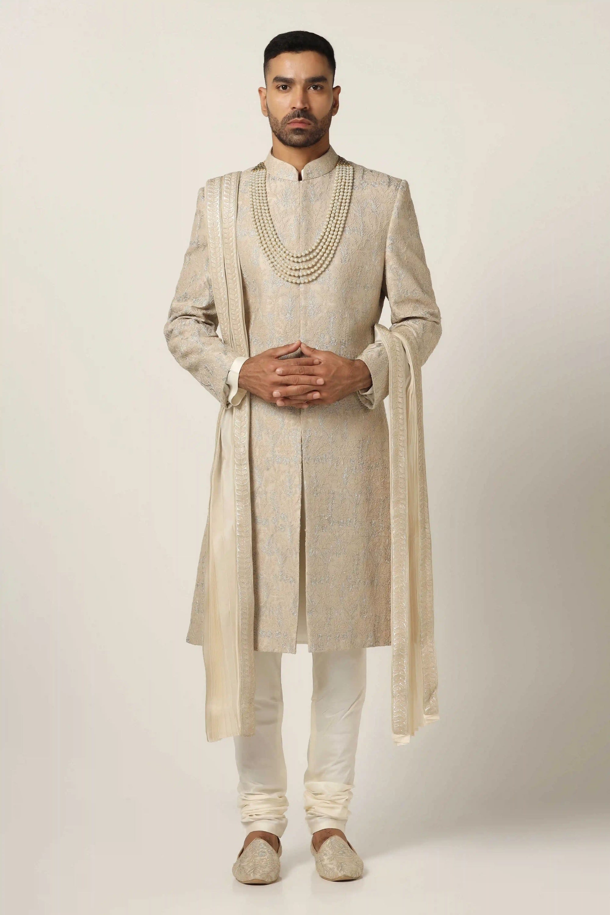 Drape in luxury with our Raw silk Sherwani set, boasting machine embroidery throughout. Shop Now!