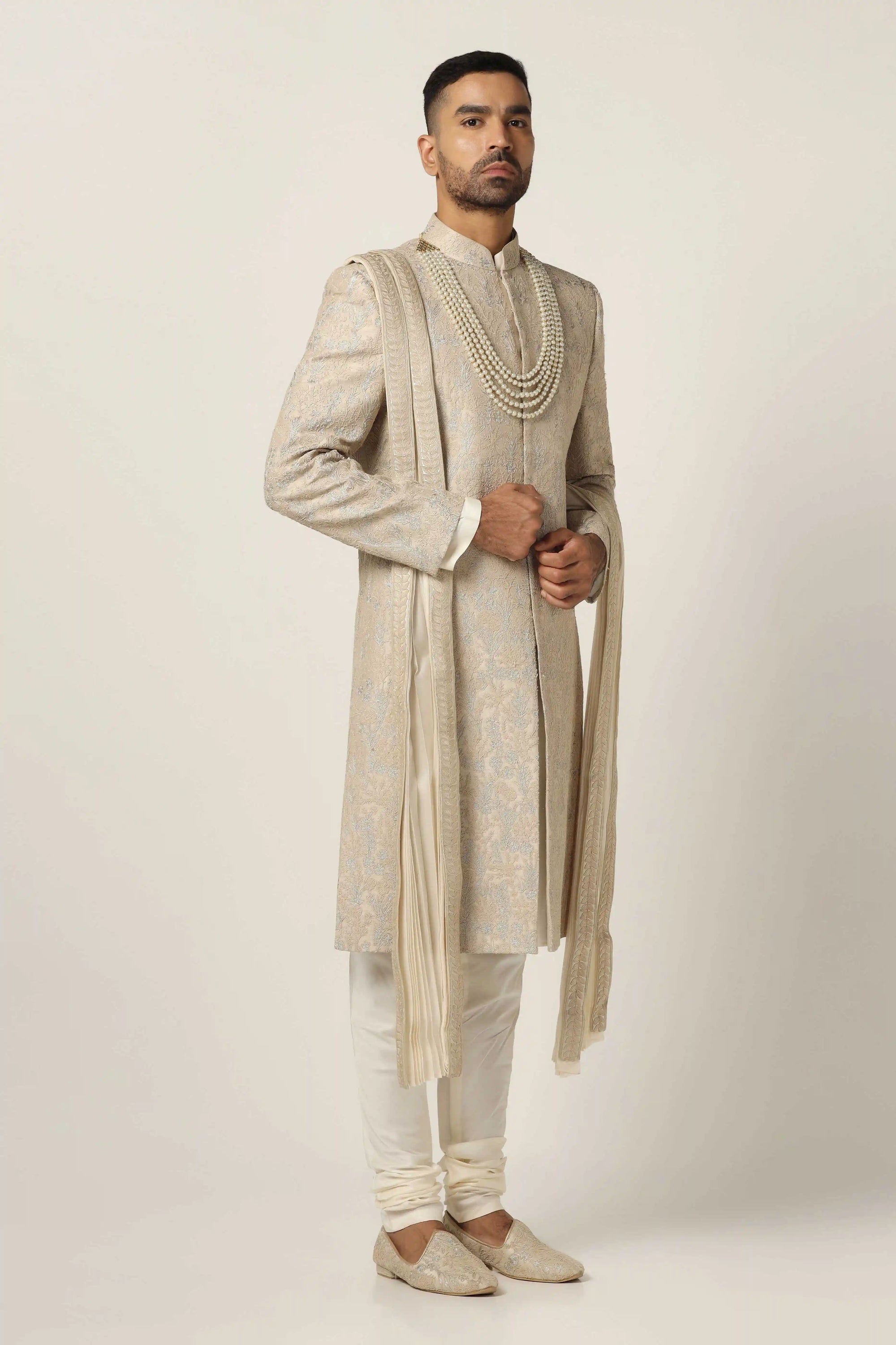 Drape in luxury with our Raw silk Sherwani set, boasting machine embroidery throughout. Shop Now!