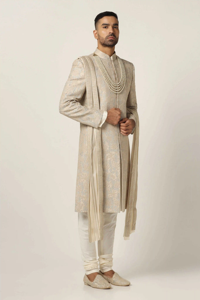 Drape in luxury with our Raw silk Sherwani set, boasting machine embroidery throughout. Complete with Kurta Pajama ensemble for timeless elegance.