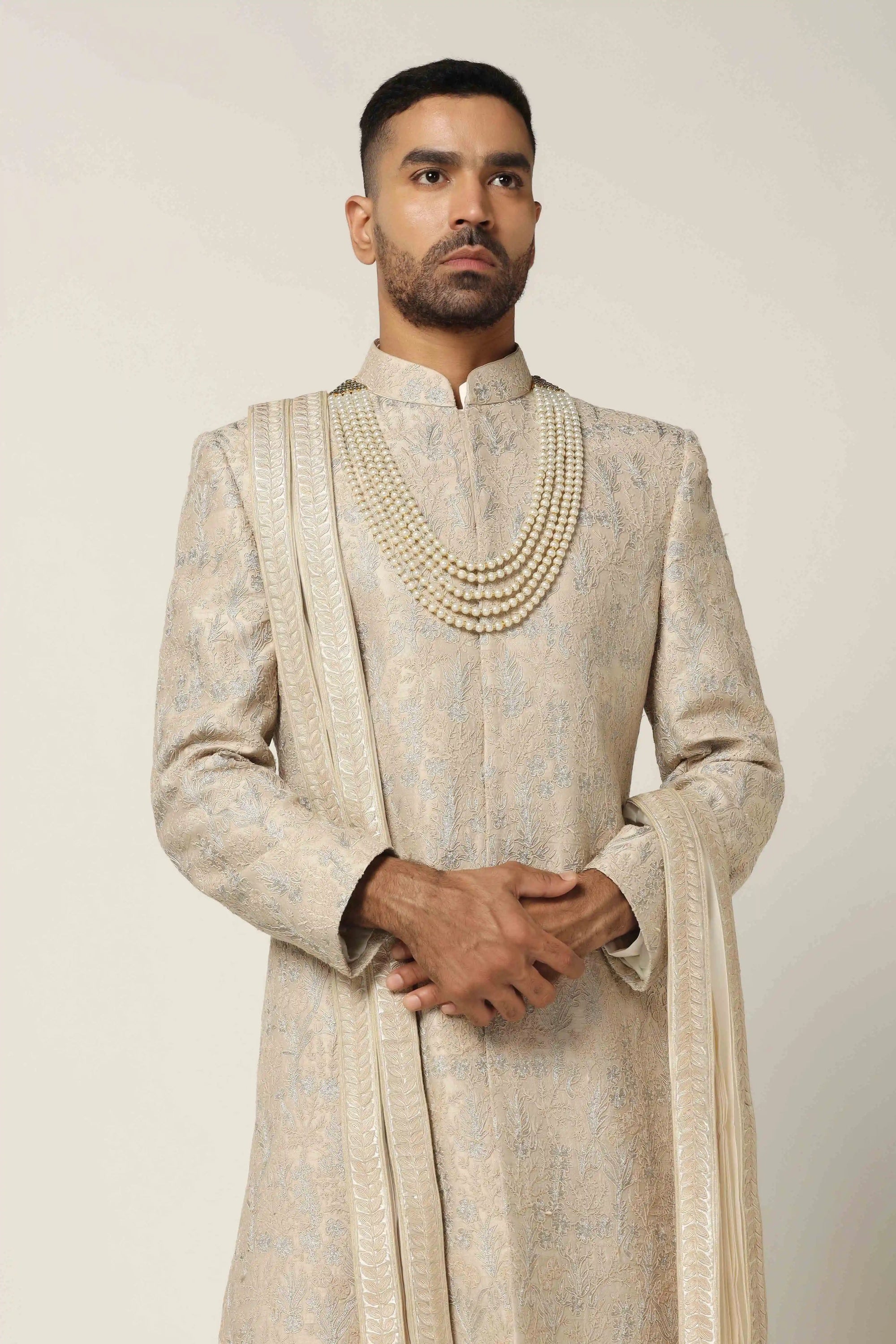 Drape in luxury with our Raw silk Sherwani set, boasting machine embroidery throughout. Shop Now!