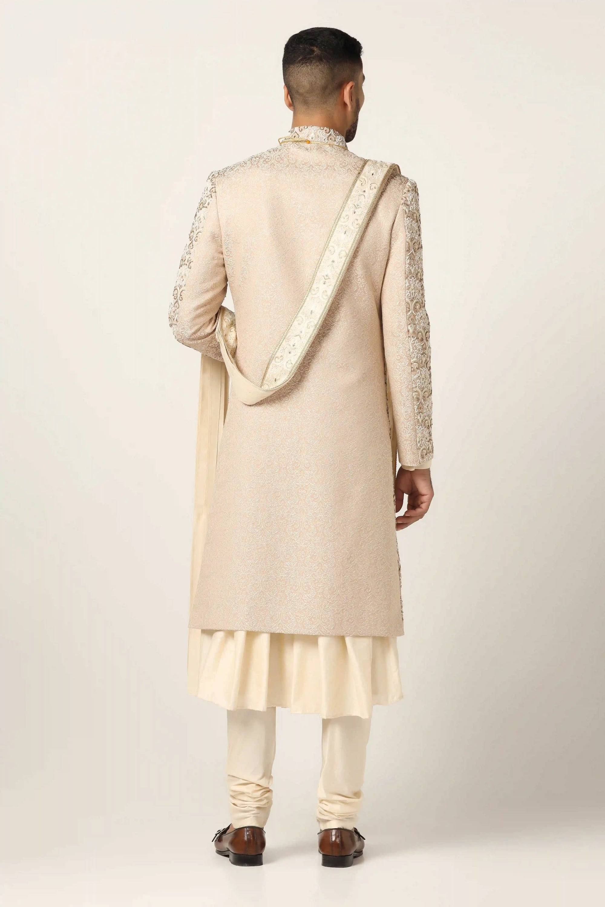 Elevate your style with our beige Sherwani, adorned with floral and geometric embroidery. Shop Now!