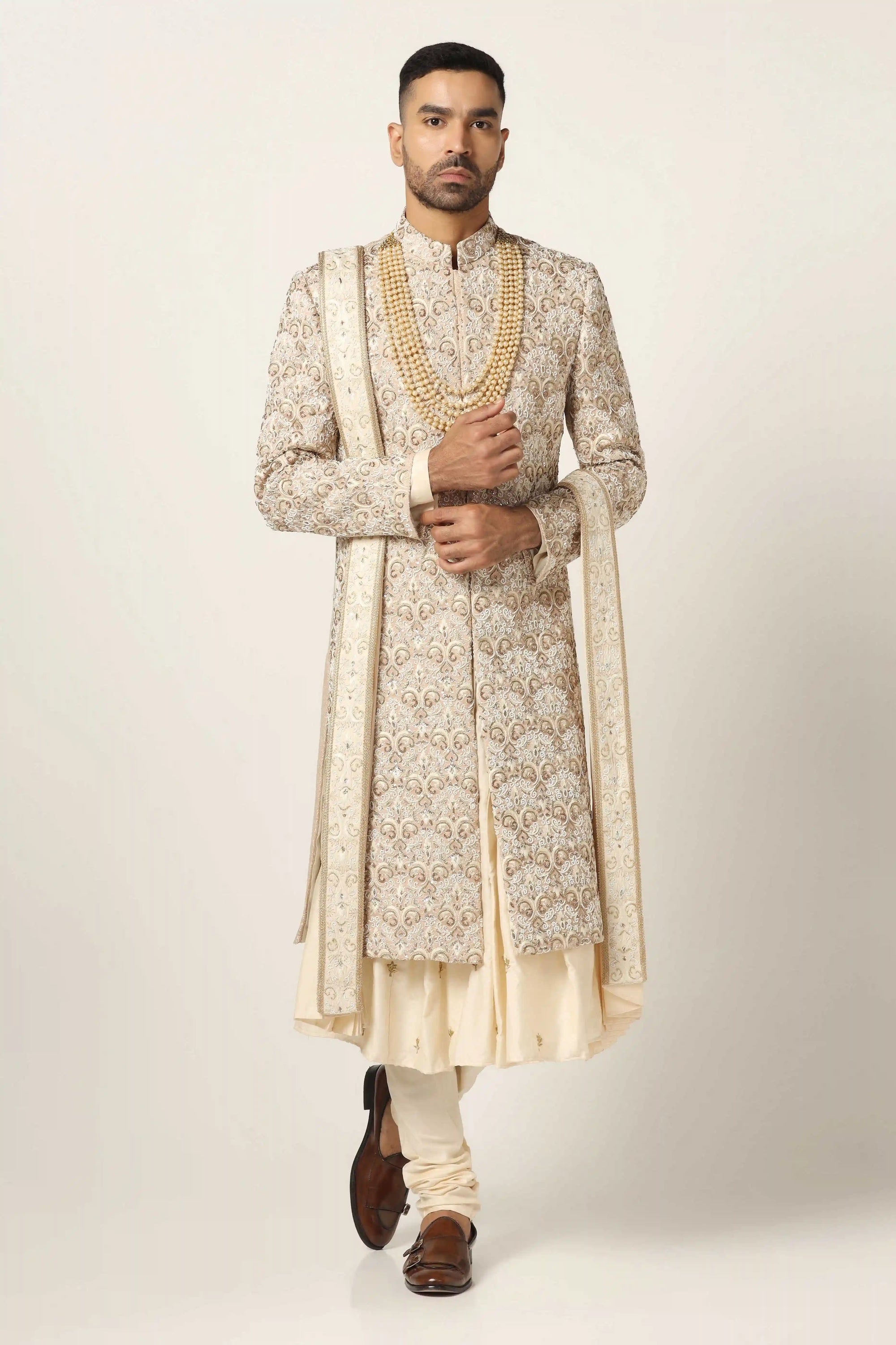 Elevate your style with our beige Sherwani, adorned with floral and geometric embroidery. Shop Now!