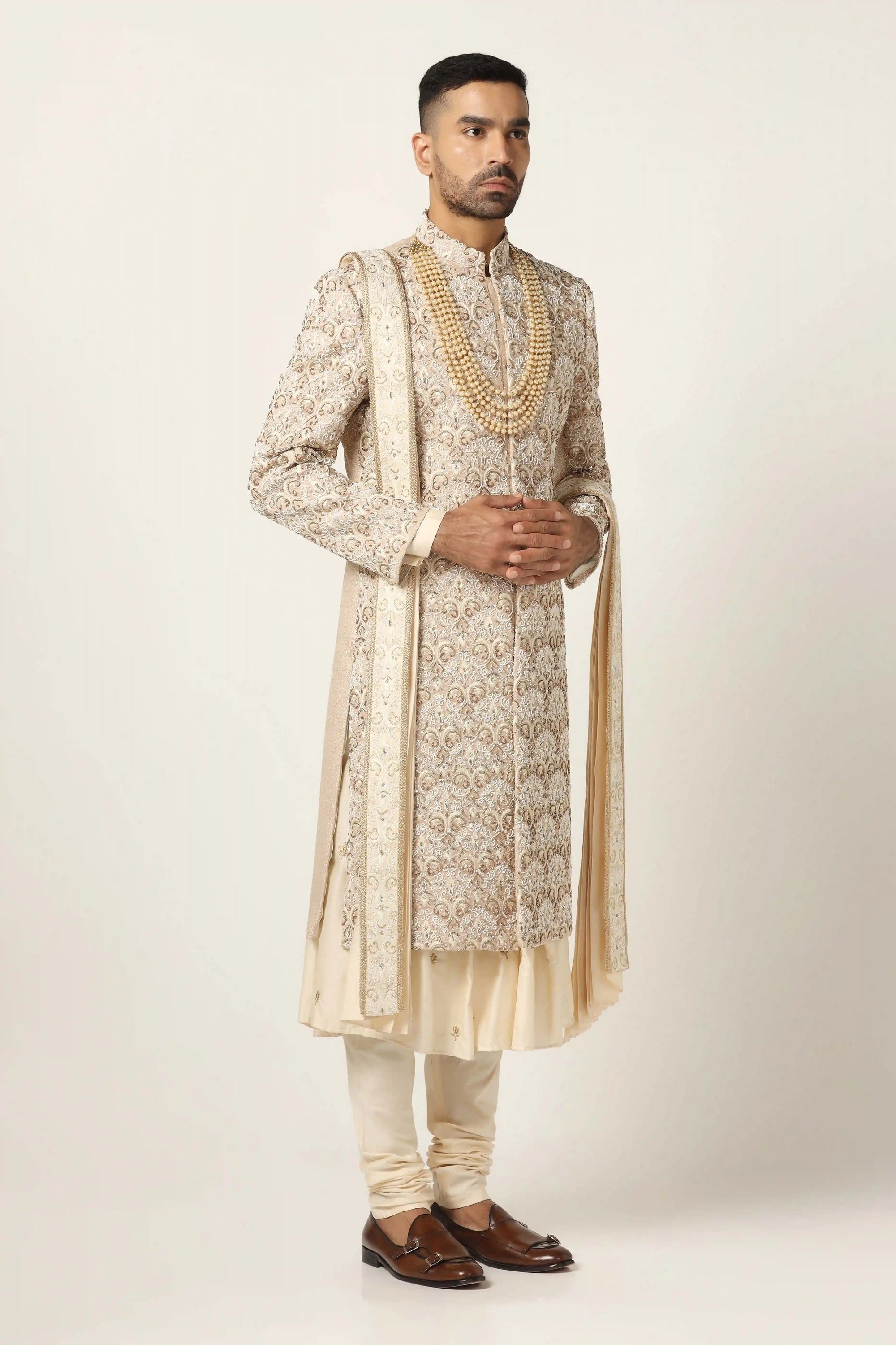 Elevate your style with our beige Sherwani, adorned with floral and geometric embroidery. Shop Now!