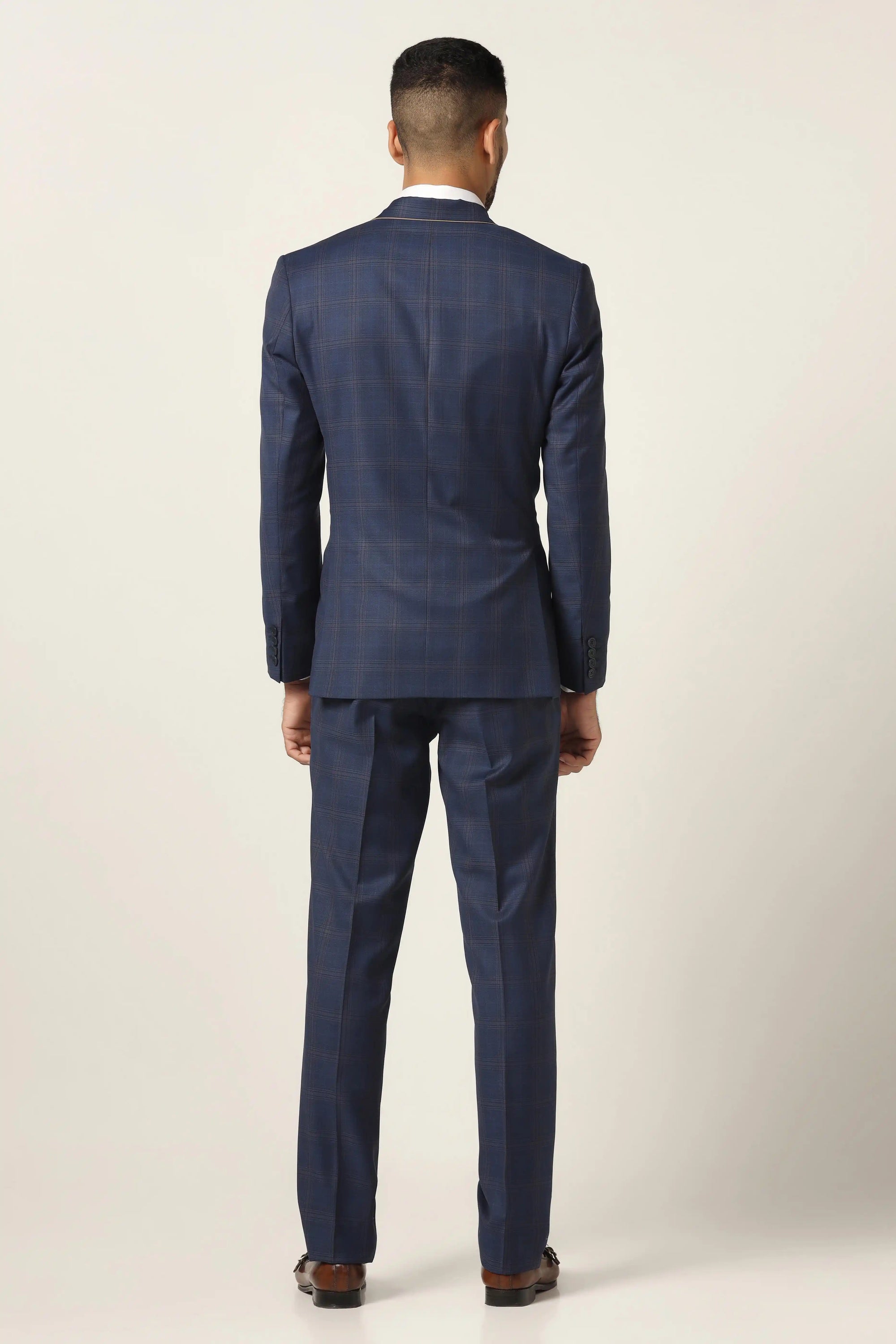 Embrace refined style with our blue suit. Classic checked design for timeless elegance. Shop Now!