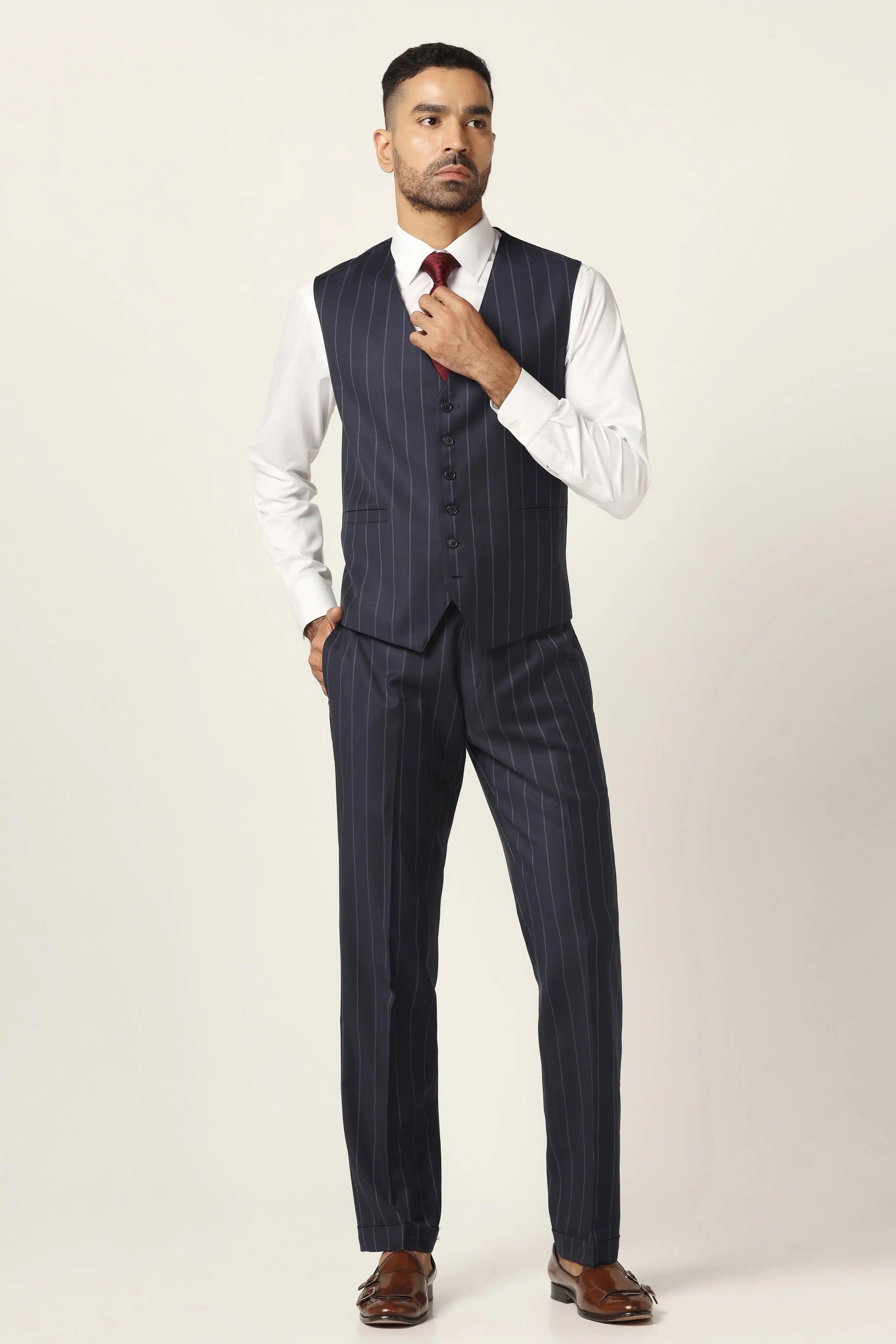 Redefine formalwear with this navy blue suit, featuring a sleek pinstripe pattern. Shop now!