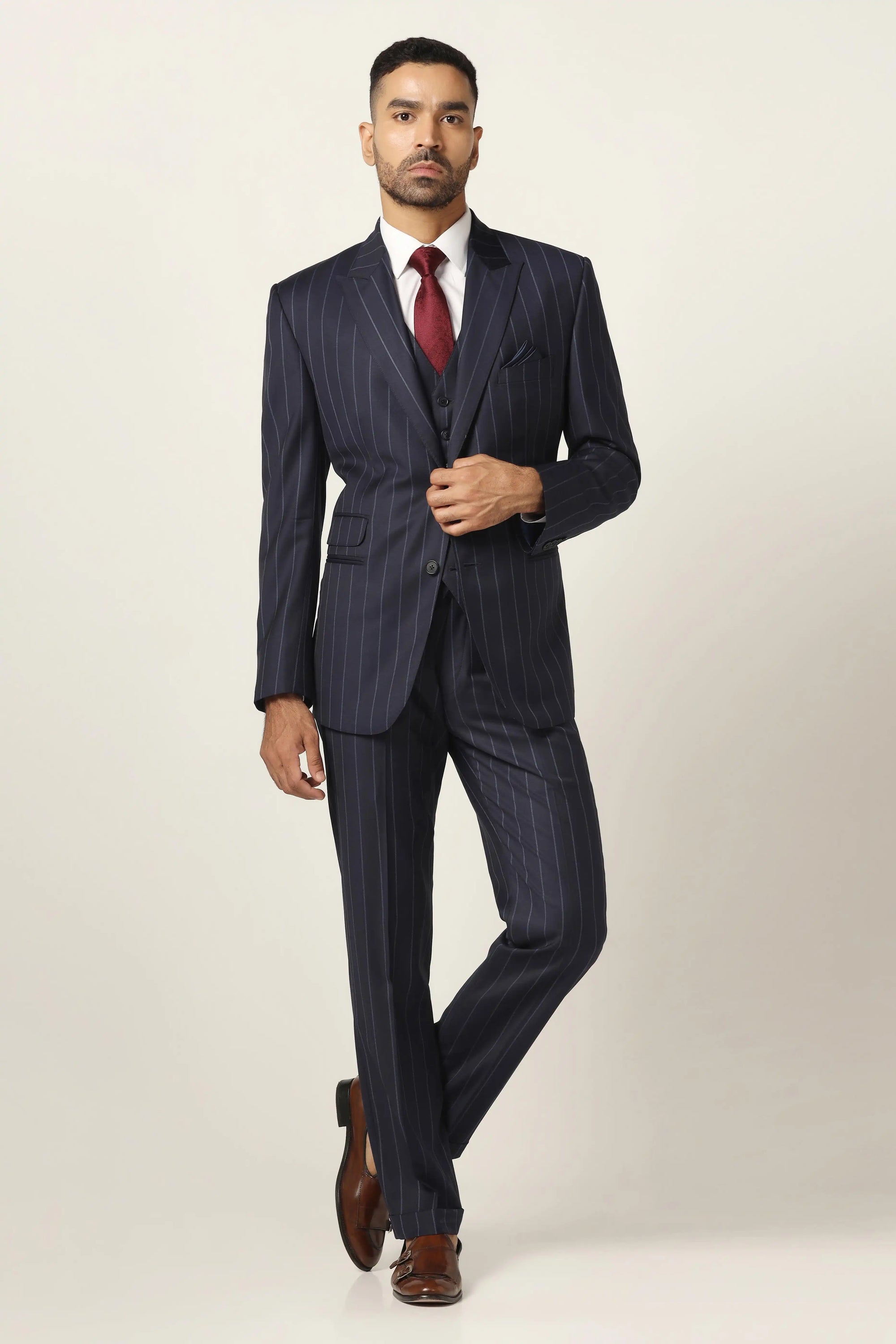 Redefine formalwear with this navy blue suit, featuring a sleek pinstripe pattern. Shop now!