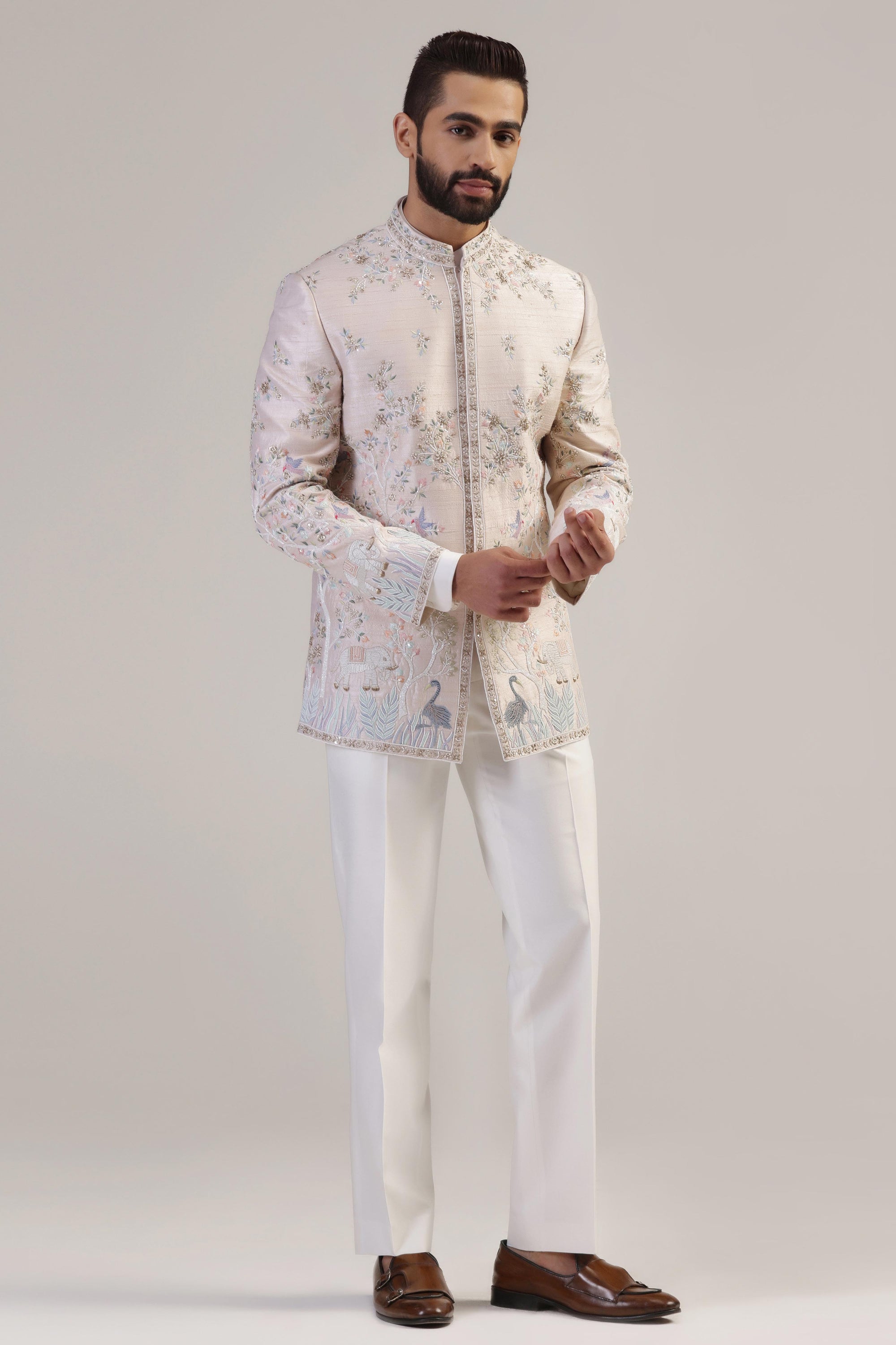 This Peach Embroidered Bandhgala suit is made with raw silk fabric. Shop Now!