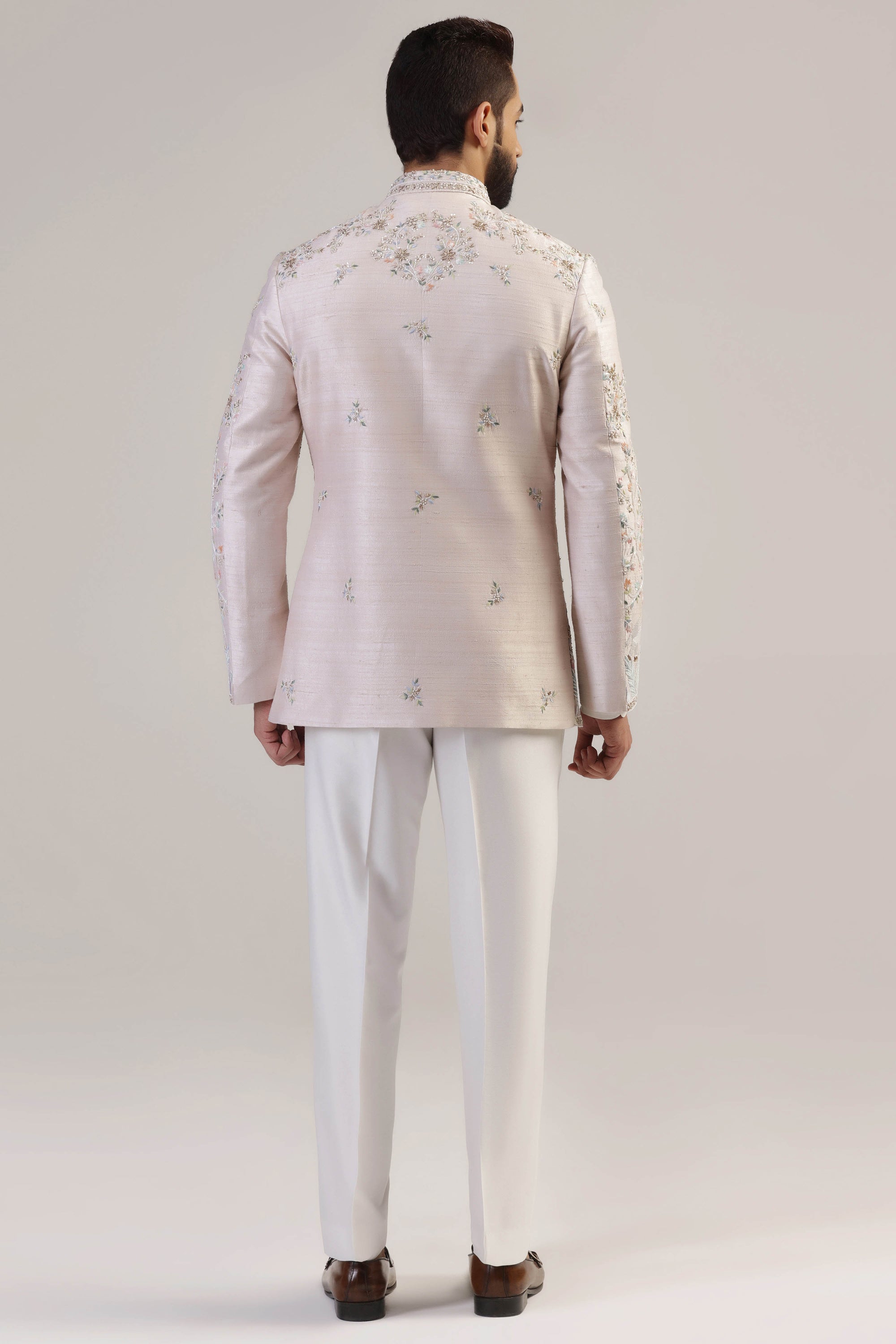 This Peach Embroidered Bandhgala suit is made with raw silk fabric. Shop Now!