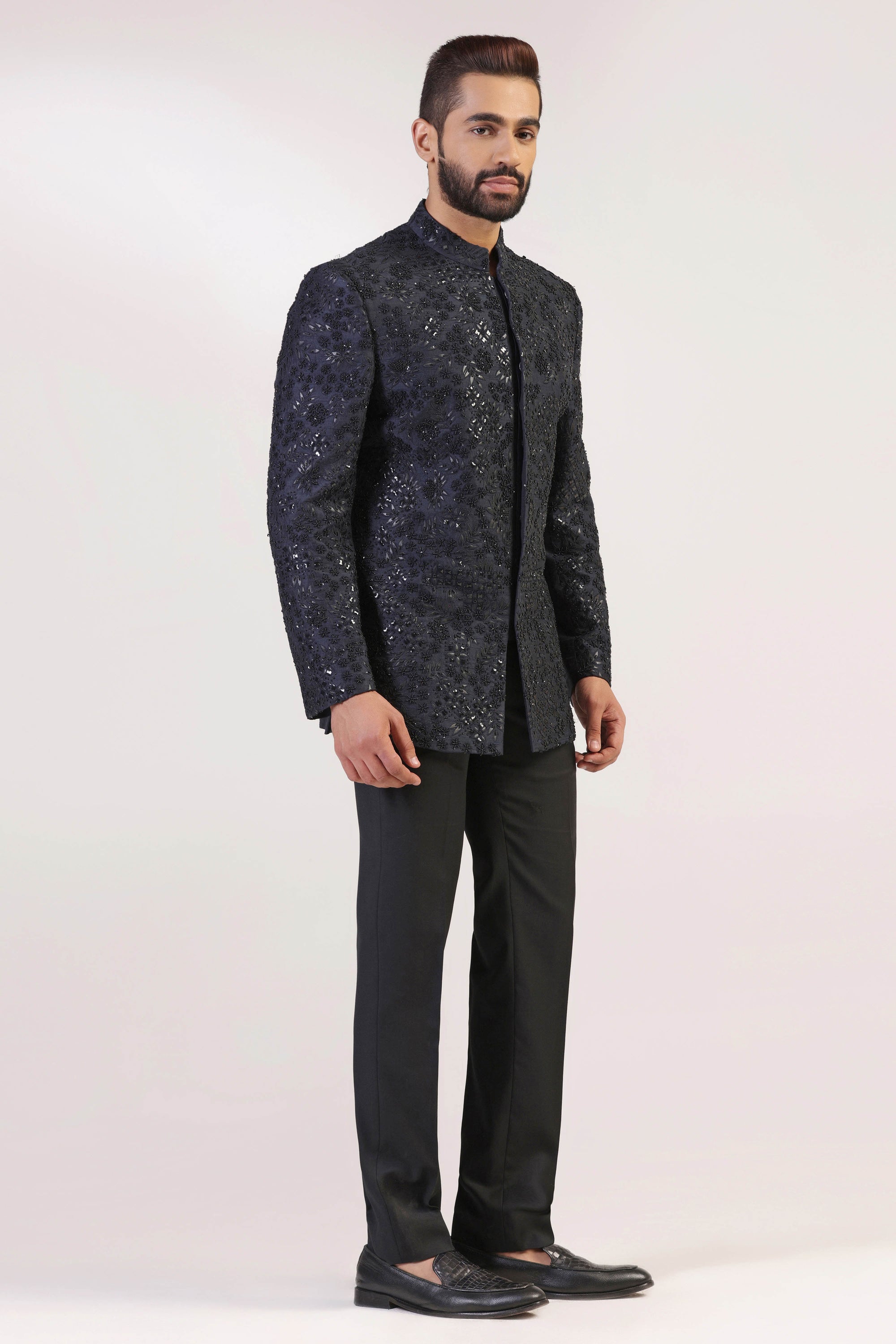 This Bandhgala Suit is expertly crafted in raw silk and highlighted by tonal embroidery. Shop Now!