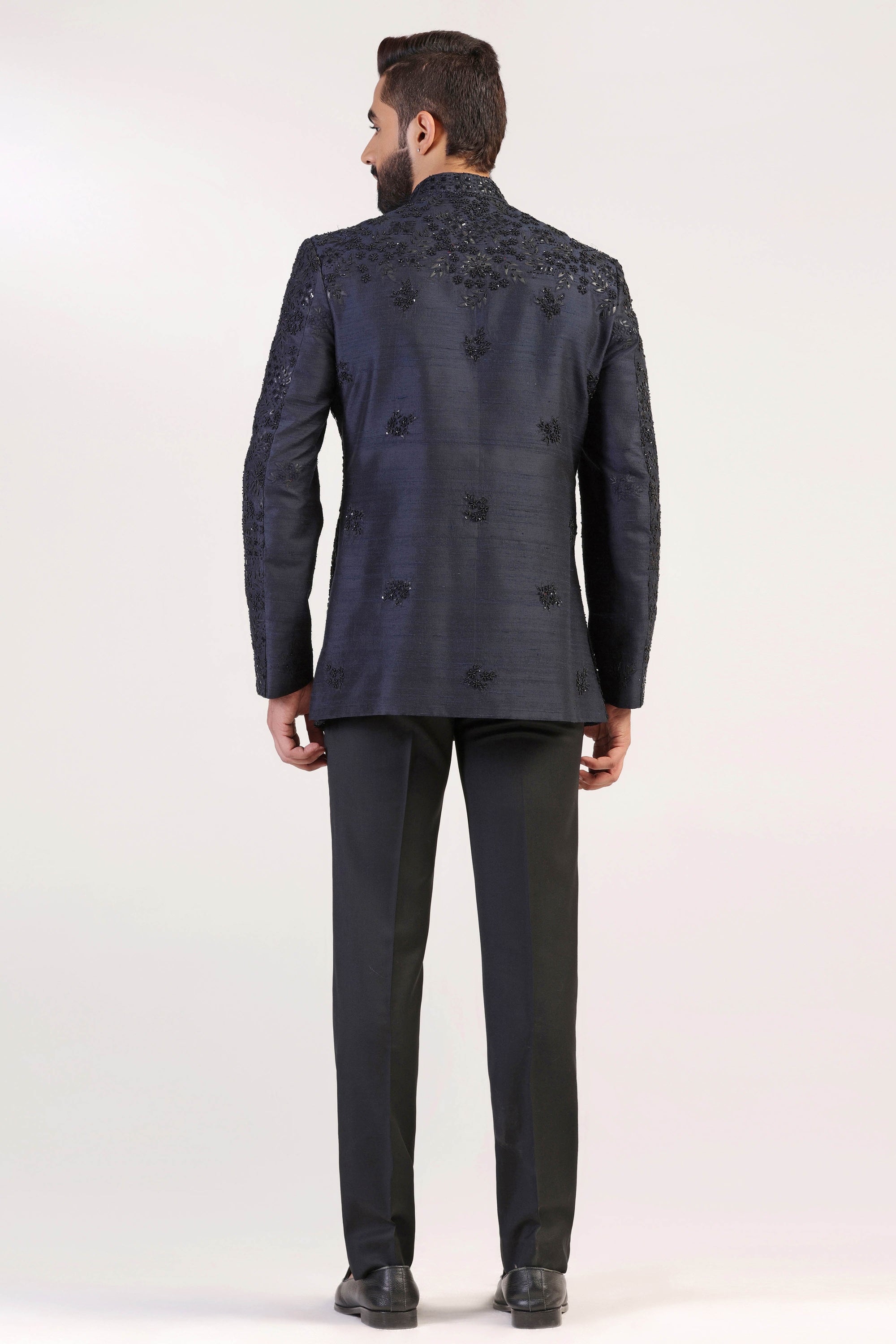 This Bandhgala Suit is expertly crafted in raw silk and highlighted by tonal embroidery. Shop Now!