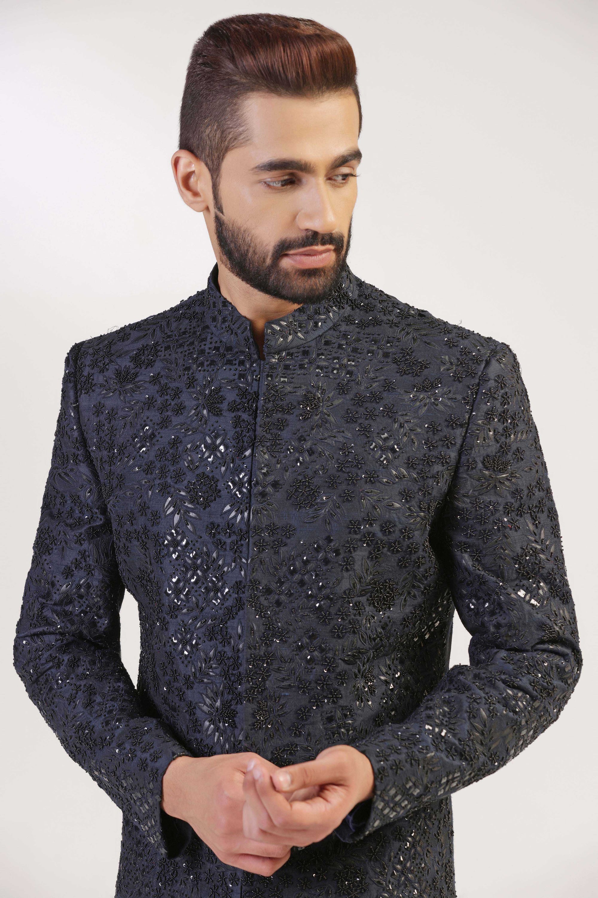 This Bandhgala Suit is expertly crafted in raw silk and highlighted by tonal embroidery. Shop Now!
