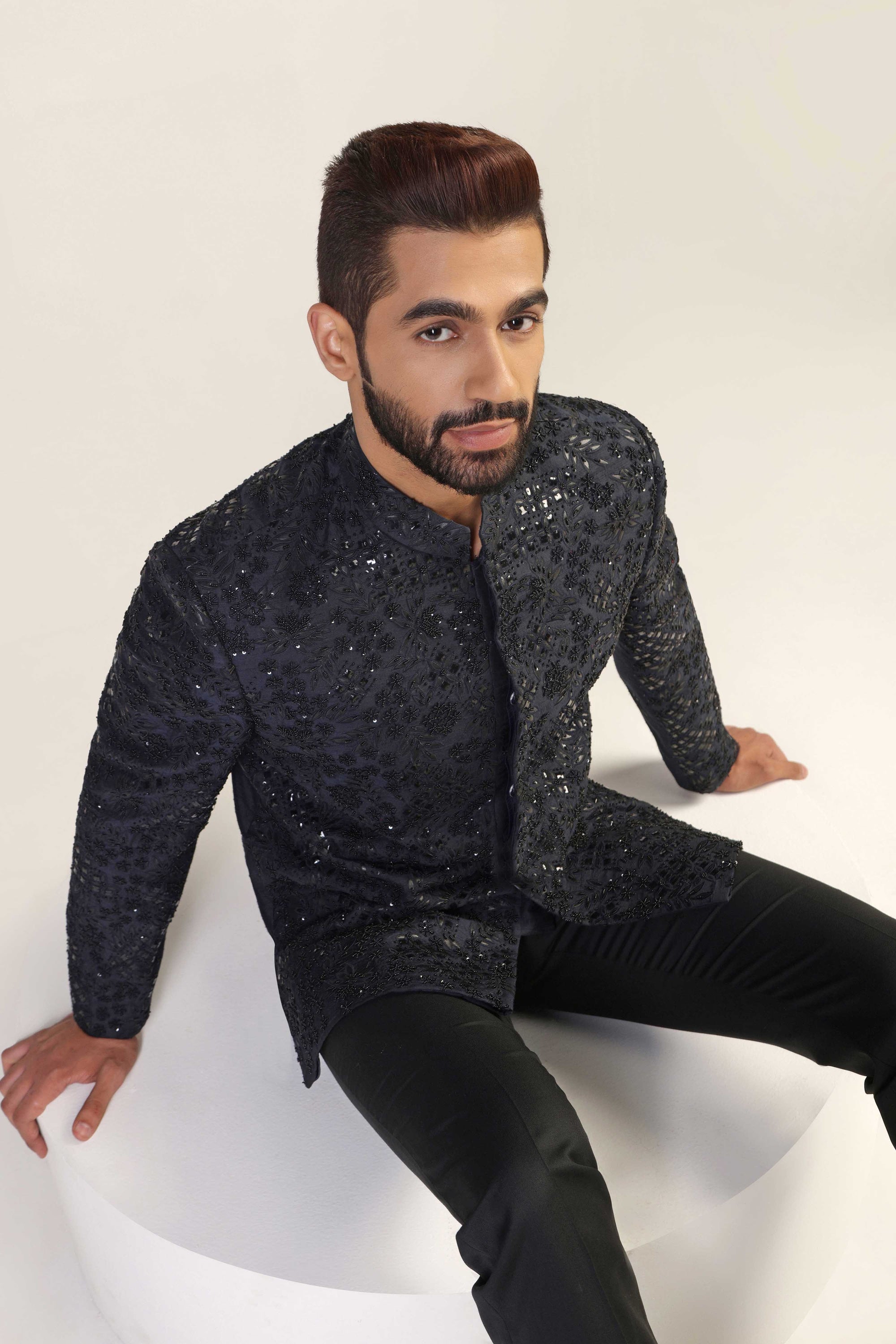 This Bandhgala Suit is expertly crafted in raw silk and highlighted by tonal embroidery. Shop Now!