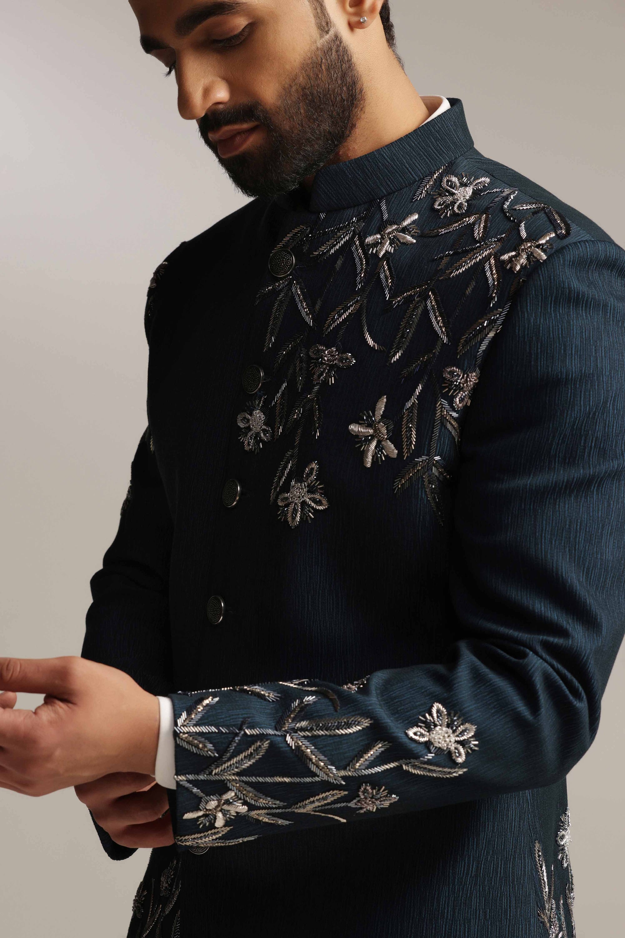 Crafted from wool fabric, this Green Bandhgala suit exudes elegance and sophistication. Shop Now!