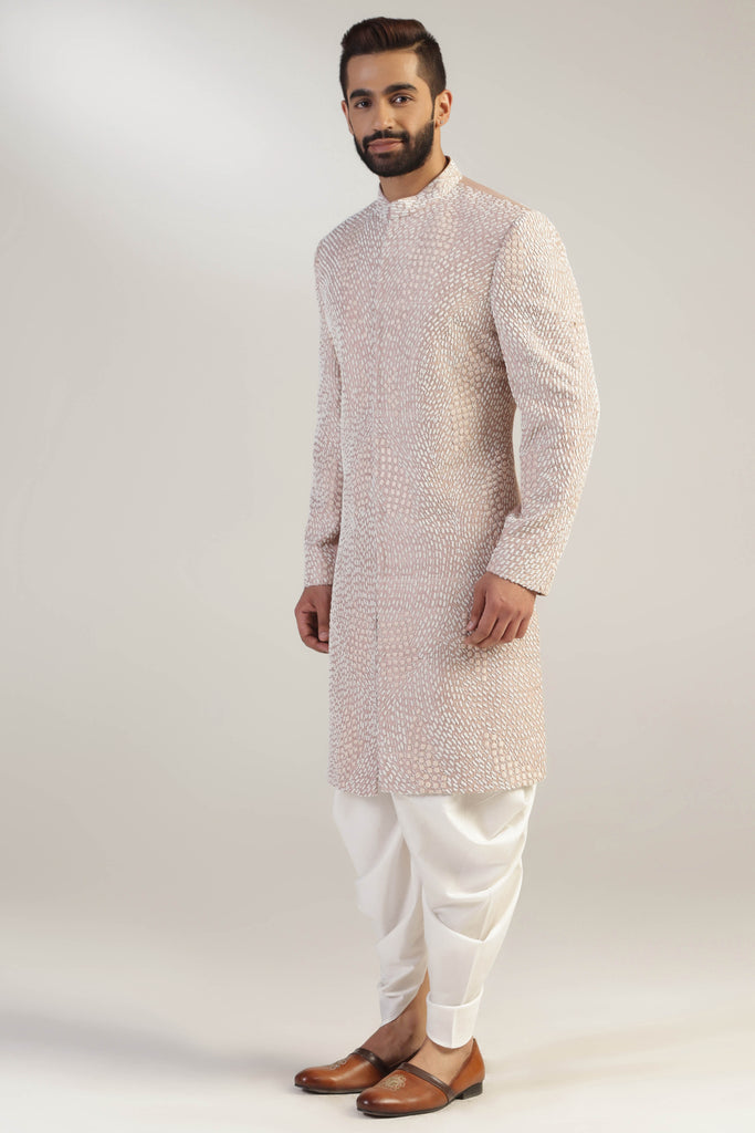 This attire is of fine raw silk fabric, featuring intricate thread and bead embroidery. Shop Now!