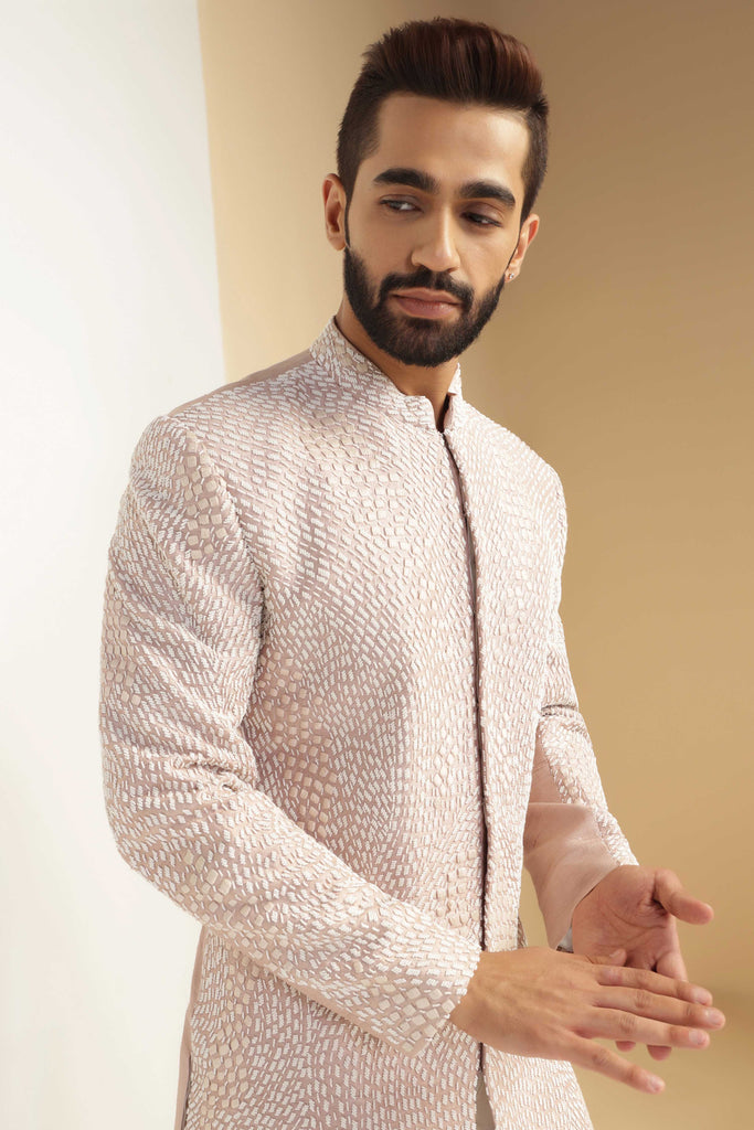 This attire is of fine raw silk fabric, featuring intricate thread and bead embroidery. Shop Now!