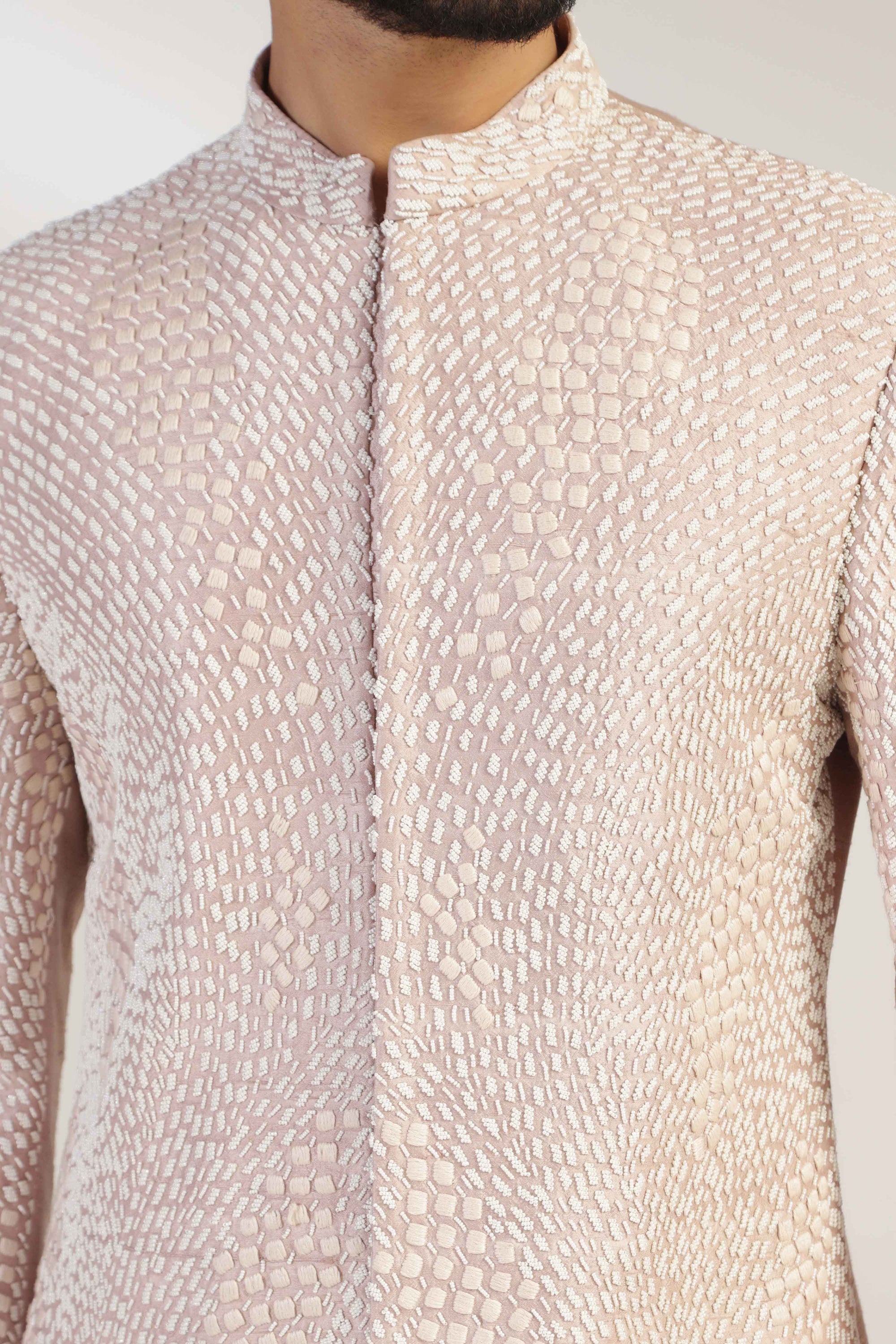 This attire is of fine raw silk fabric, featuring intricate thread and bead embroidery. Shop Now!