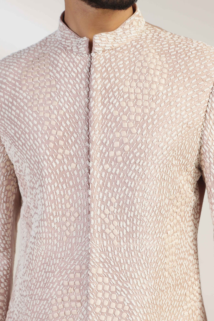This attire is of fine raw silk fabric, featuring intricate thread and bead embroidery. Shop Now!