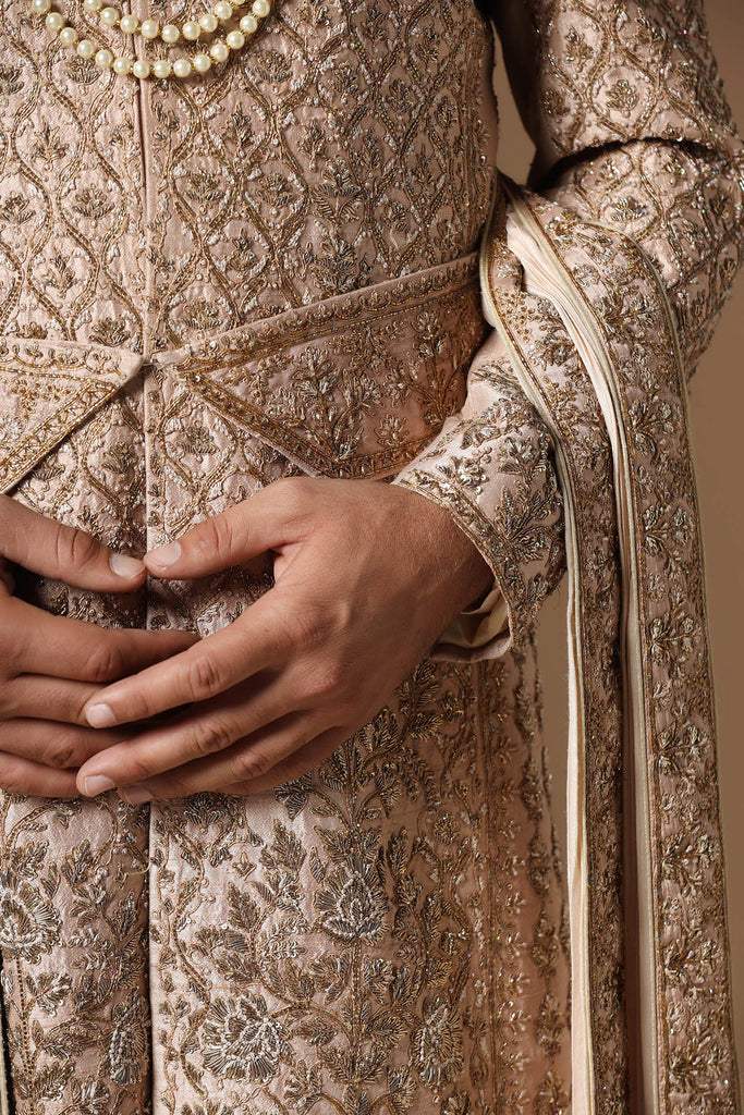 Experience our best-selling sherwani, adorned with captivating floral and geometric embroidery. Paired with a pleated kurta and pajama set for unmatched elegance.