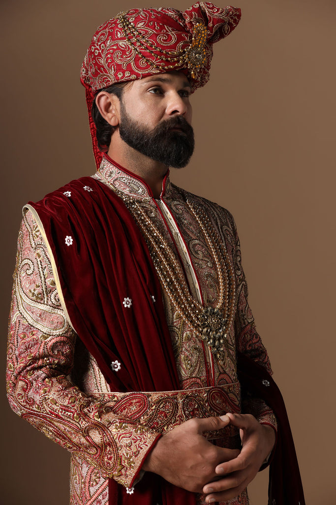 Elevate your style with our ombre embroidered Sherwani, merging Beige and Maroon tones. Exquisite embroidery adorns the body, defining sophistication.