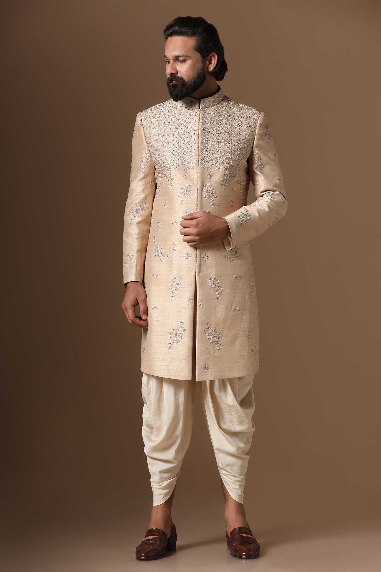 This beige Indo-Western made with raw silk fabric is highlighted by intricate embroidery. Shop Now!