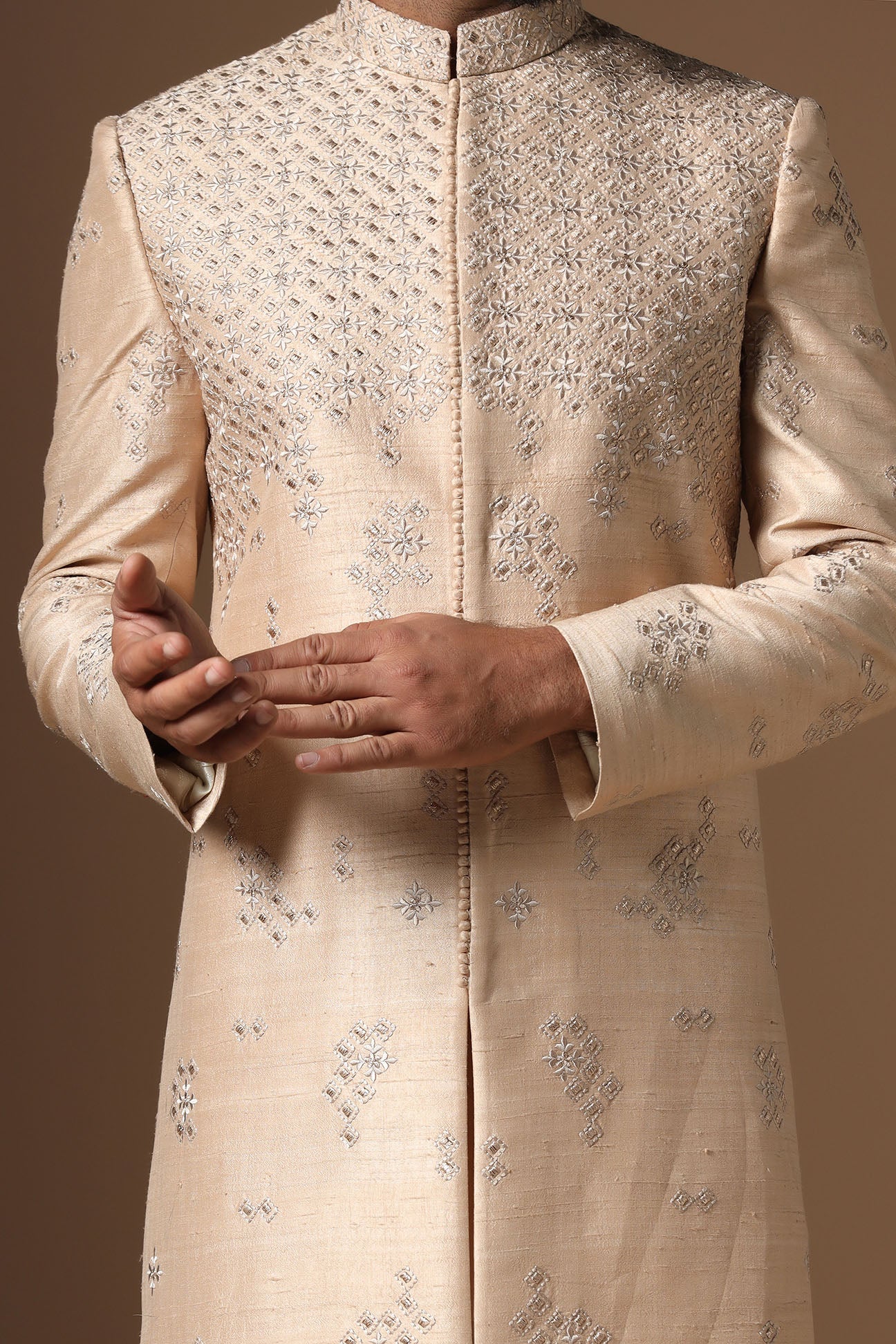 This beige Indo-Western made with raw silk fabric is highlighted by intricate embroidery. Shop Now!