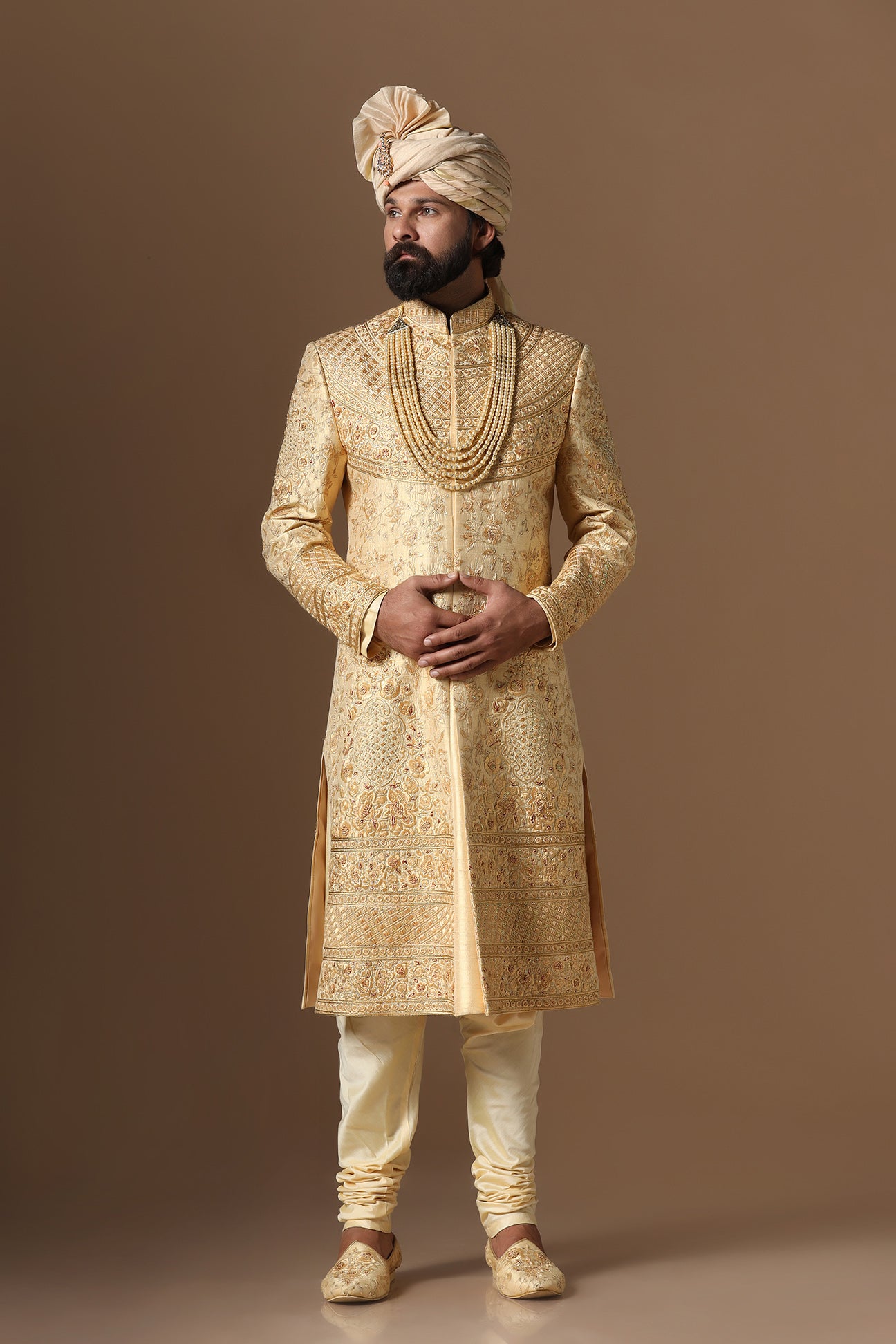 This Elegant Sherwani is highlighted by intricate geometric and floral embroidery. Shop Now!
