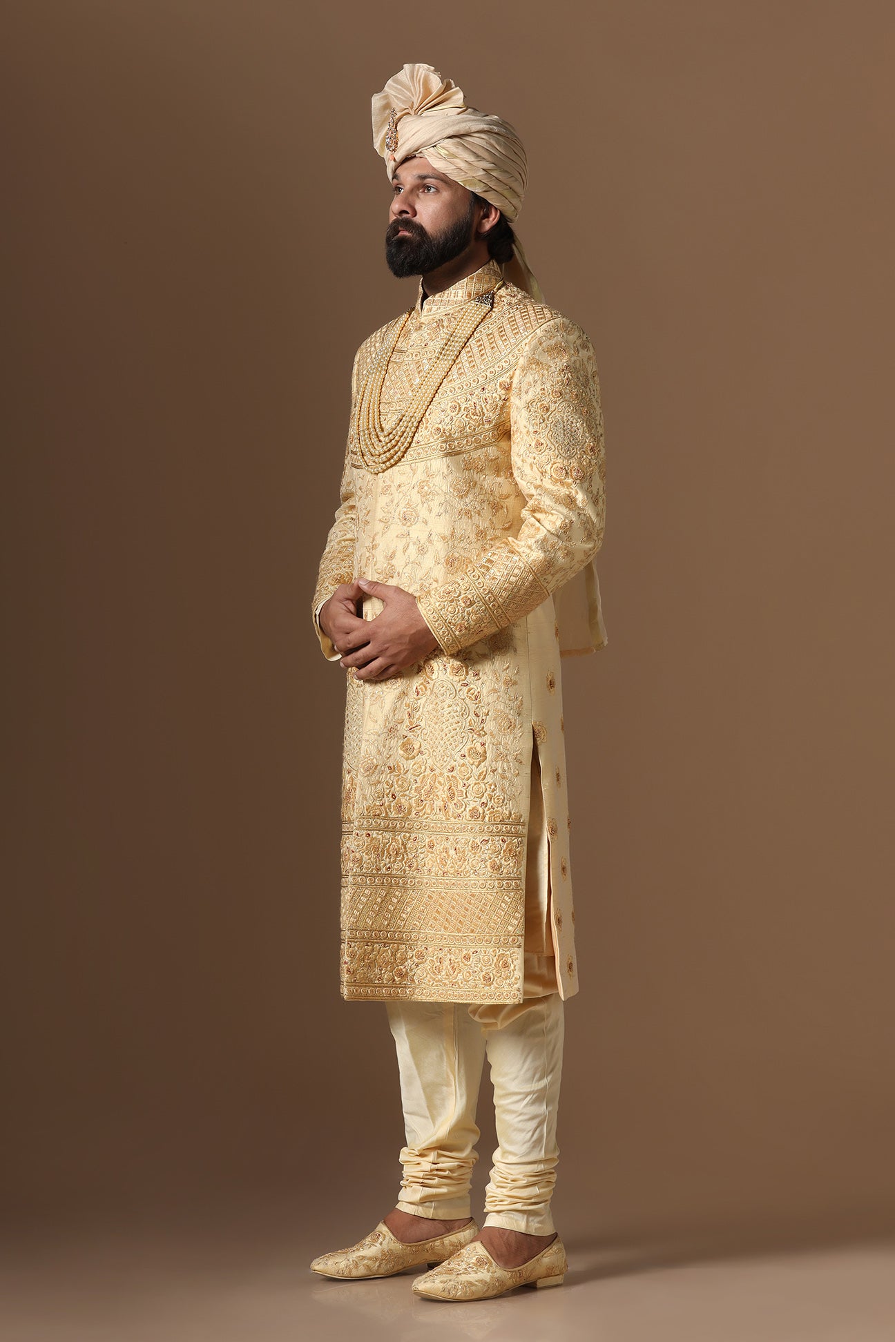 This Elegant Sherwani is highlighted by intricate geometric and floral embroidery. Shop Now!