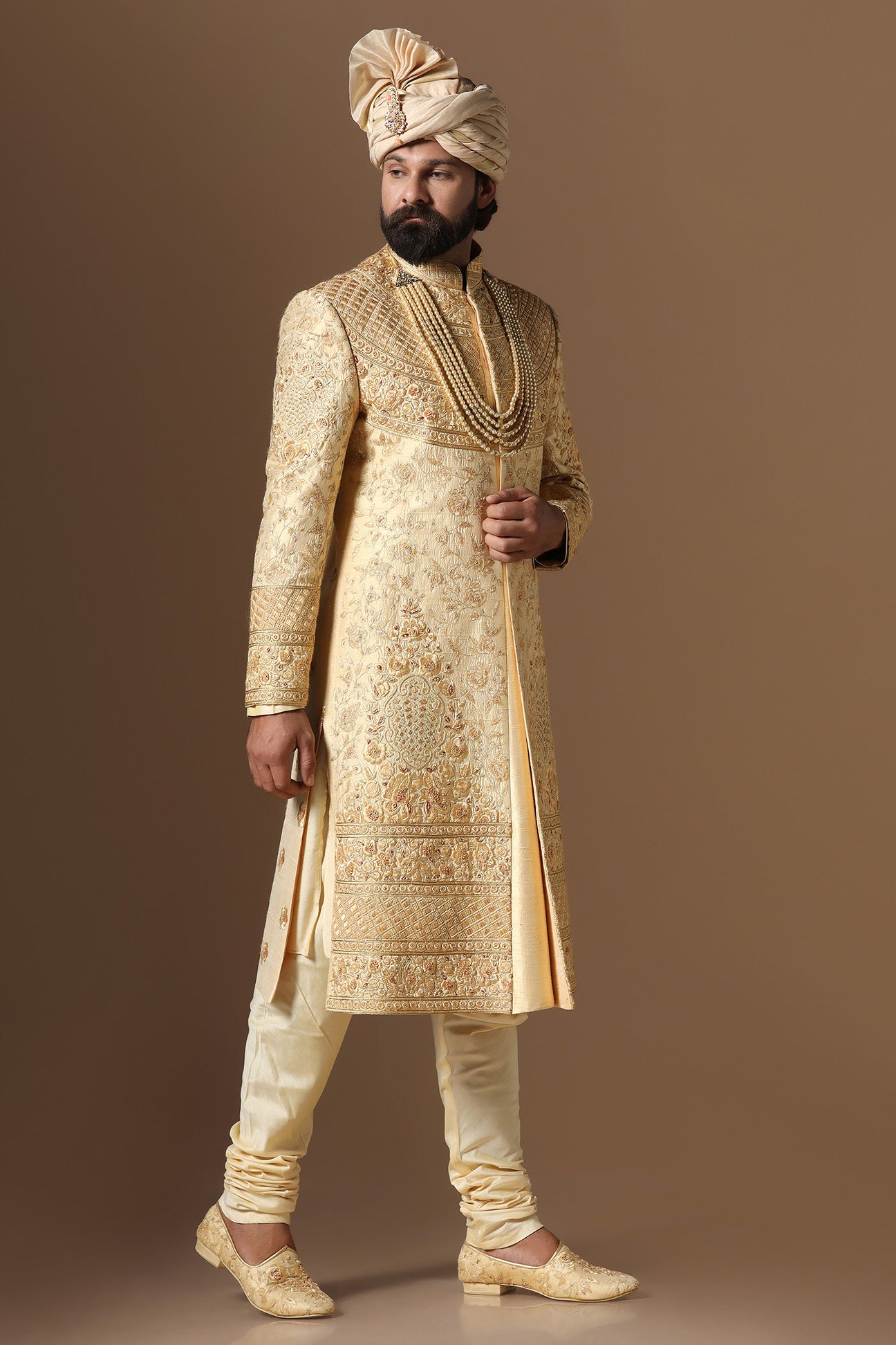 This Elegant Sherwani is highlighted by intricate geometric and floral embroidery. Shop Now!