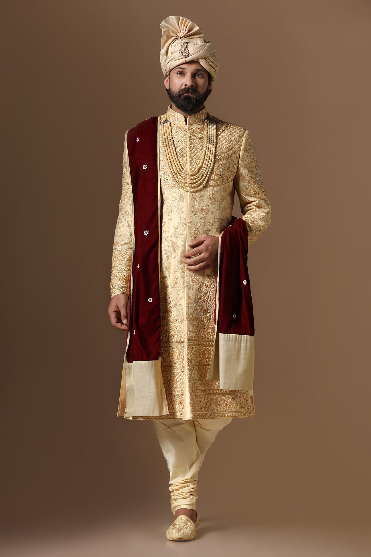 This Elegant Sherwani is highlighted by intricate geometric and floral embroidery. Shop Now!