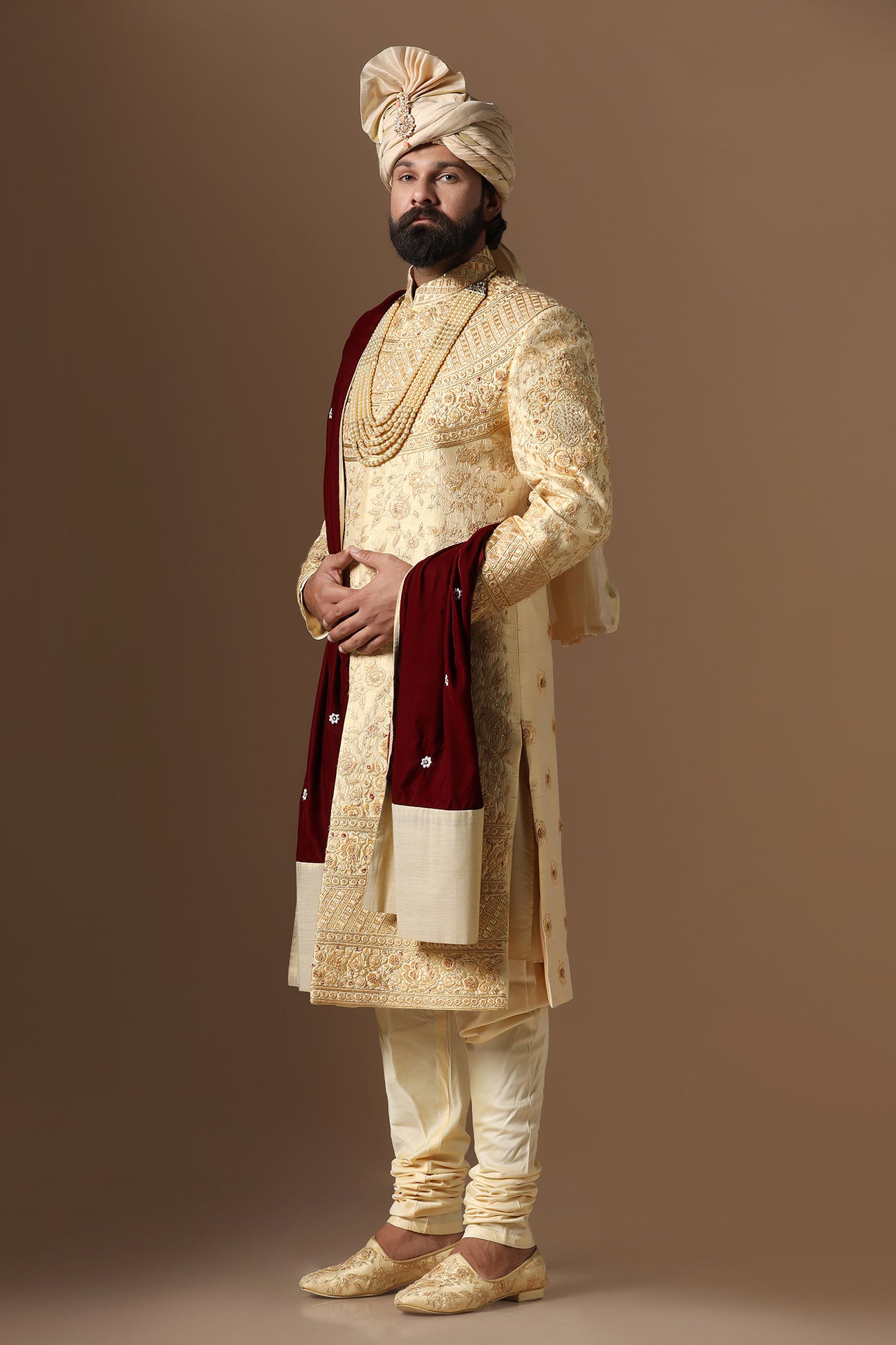 This Elegant Sherwani is highlighted by intricate geometric and floral embroidery. Shop Now!