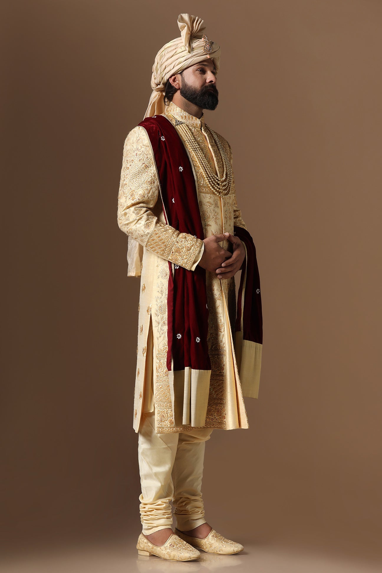 This Elegant Sherwani is highlighted by intricate geometric and floral embroidery. Shop Now!