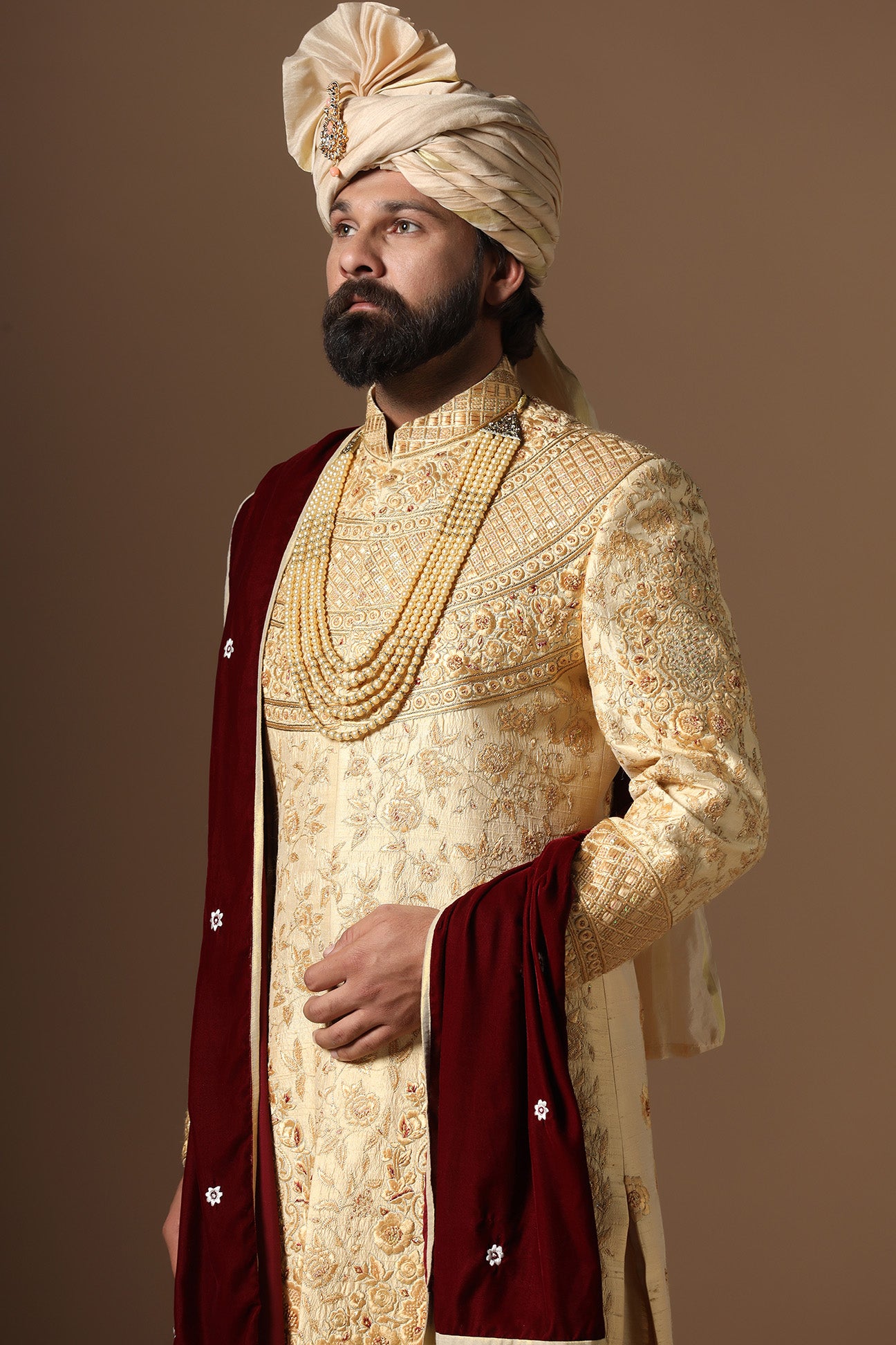 This Elegant Sherwani is highlighted by intricate geometric and floral embroidery. Shop Now!