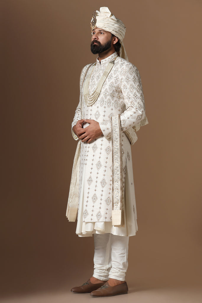 Elevate your style with this elegant Raw-Silk Sherwani, featuring captivating geometric embroidery. A timeless statement of sophistication.
