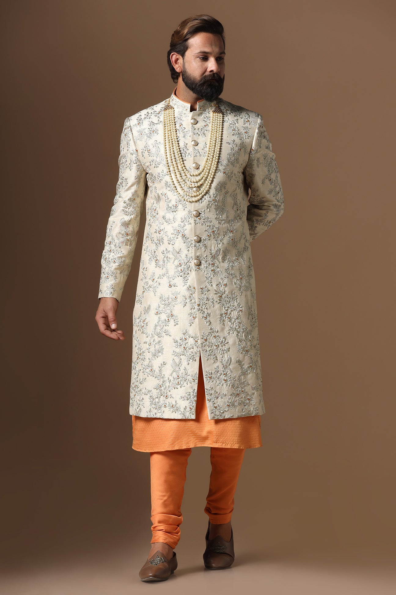 Embrace sophistication with our beige floral embroidered Sherwani. Shop Now!